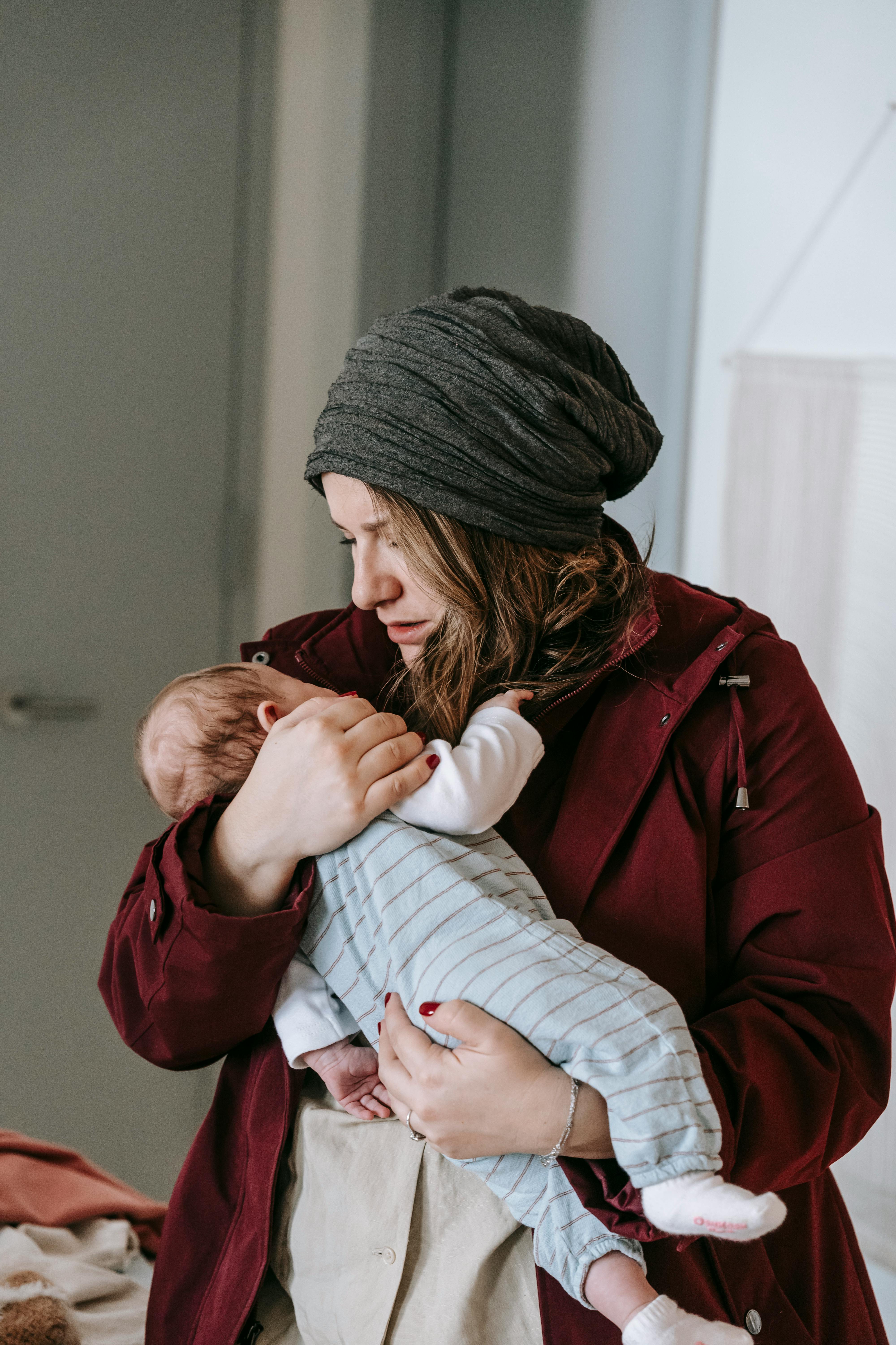 A woman with a baby in her arms | Source: Pexels