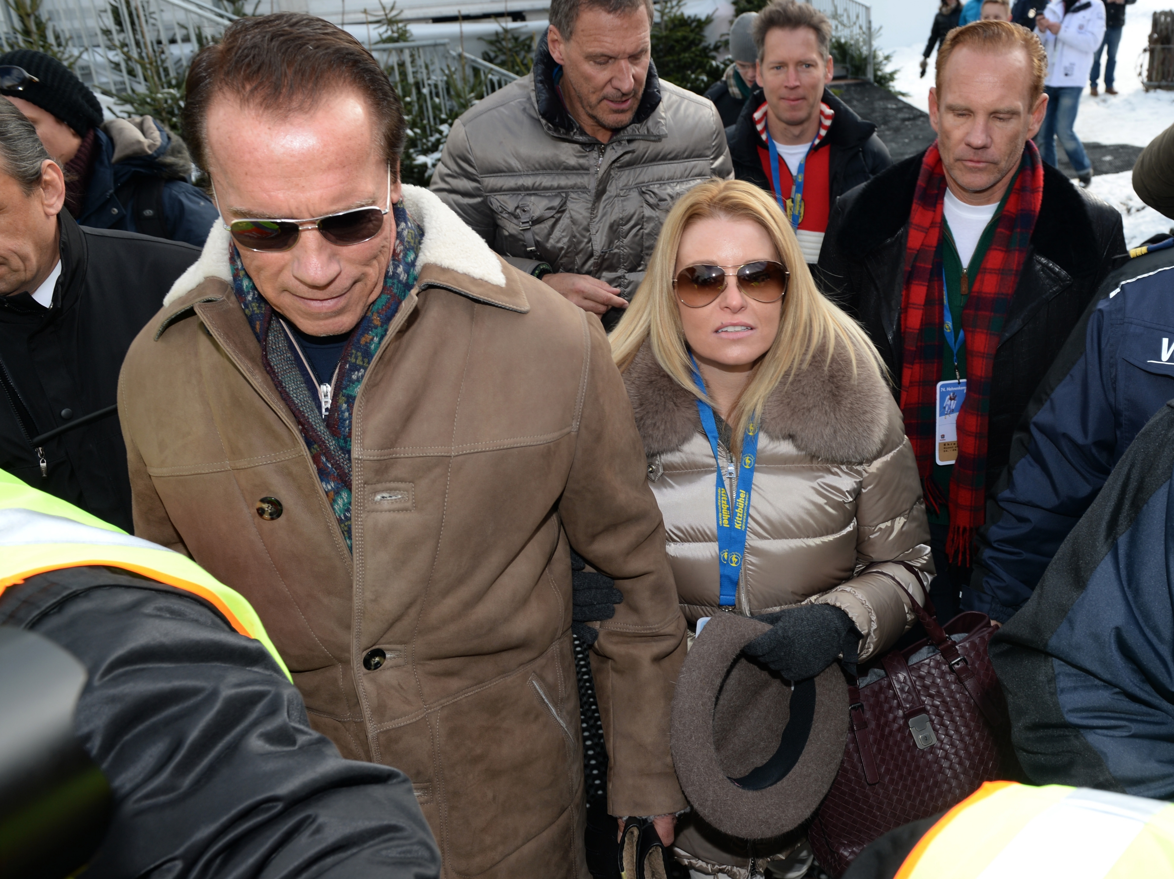 Arnold Schwarzenegger and his girlfriend Heather Milligan leave the annual Austrian downhill ski race Hahnenkamm race in Kitzbuehel, Austria on January 25, 2014 | Source: Getty Images