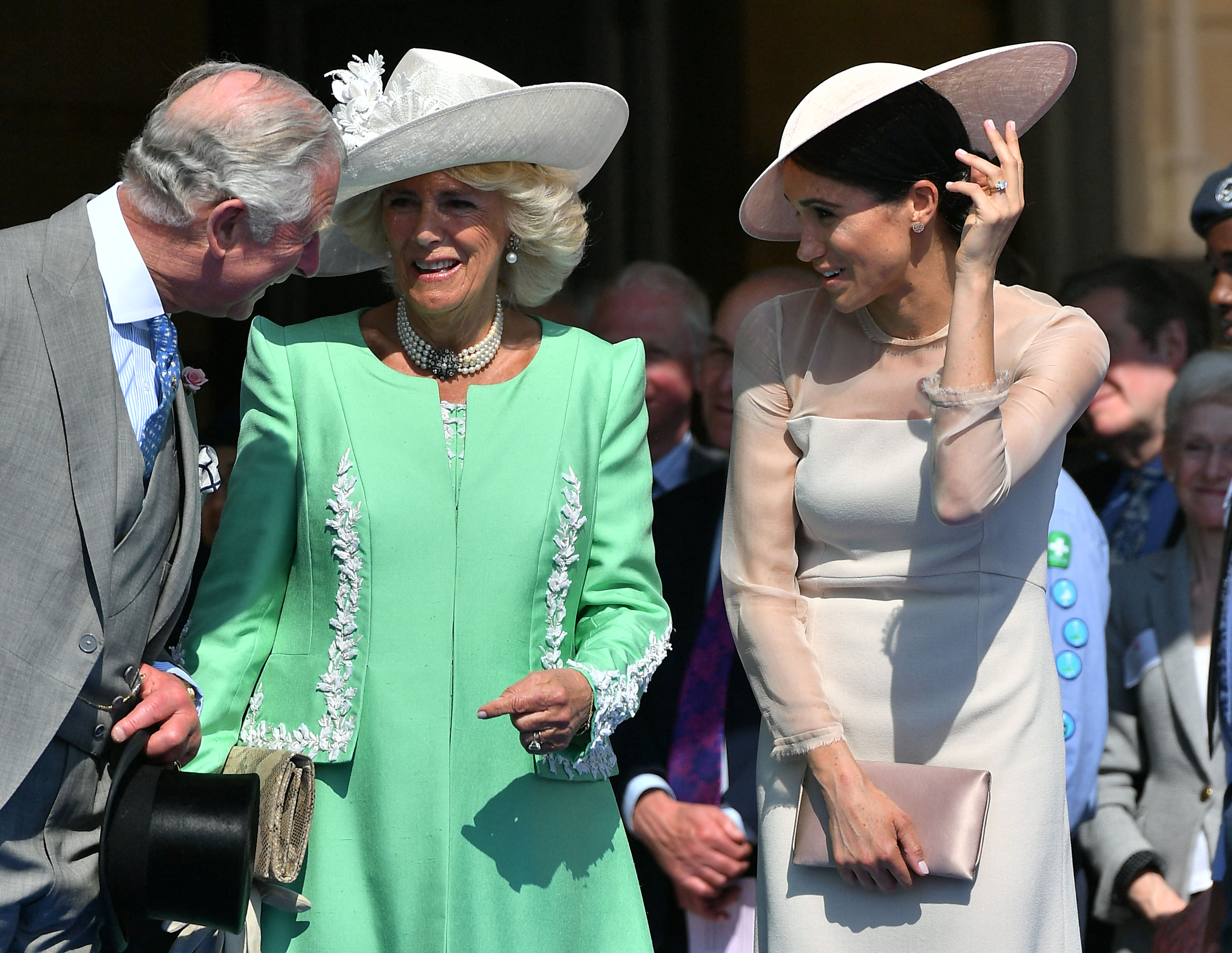 King Charles III, Queen Camilla, and Meghan Markle speaking during the Prince of Wales's 70th Birthday Garden Party in London, England on May 22, 2018 | Source: Getty Images