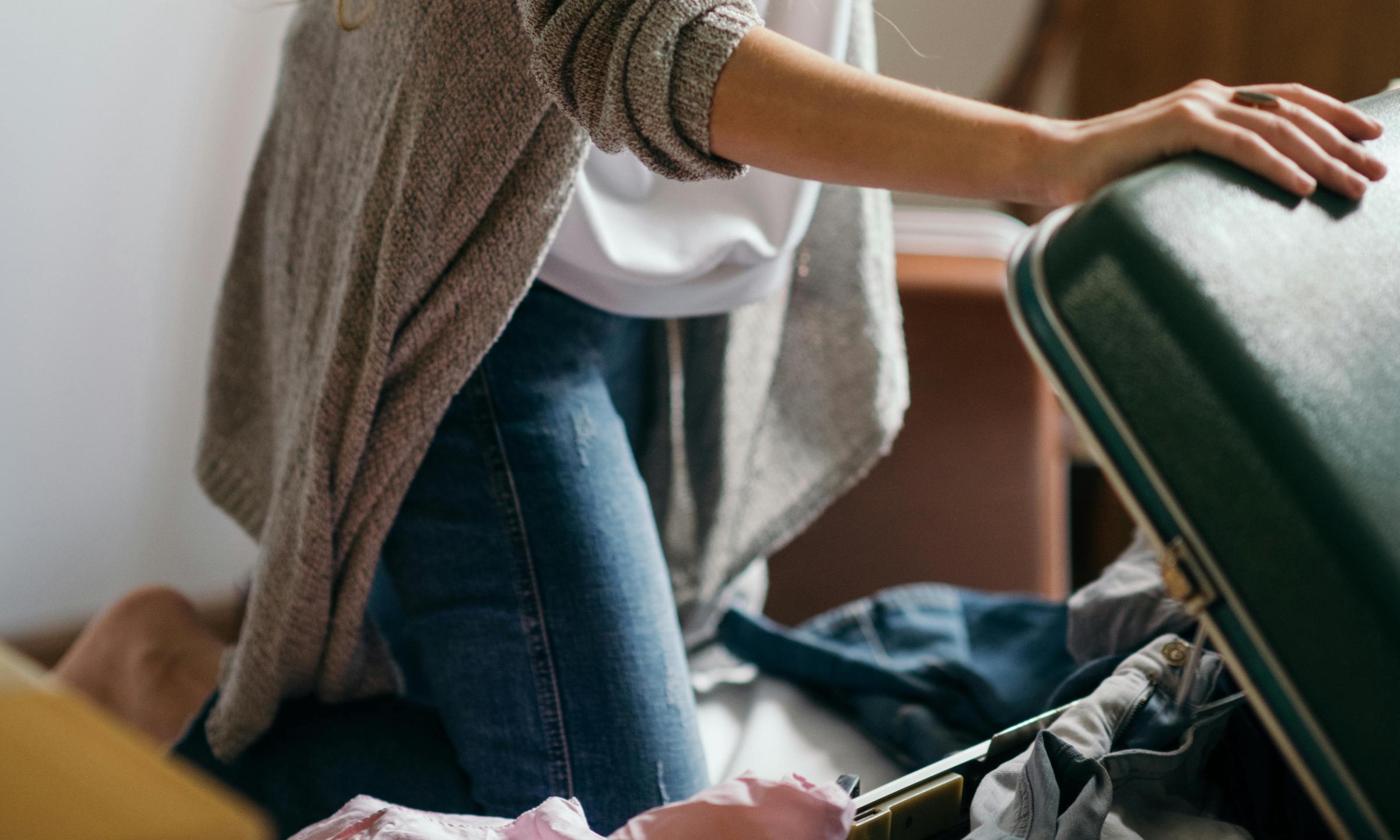 A woman packing a suitcase | Source: Pexels