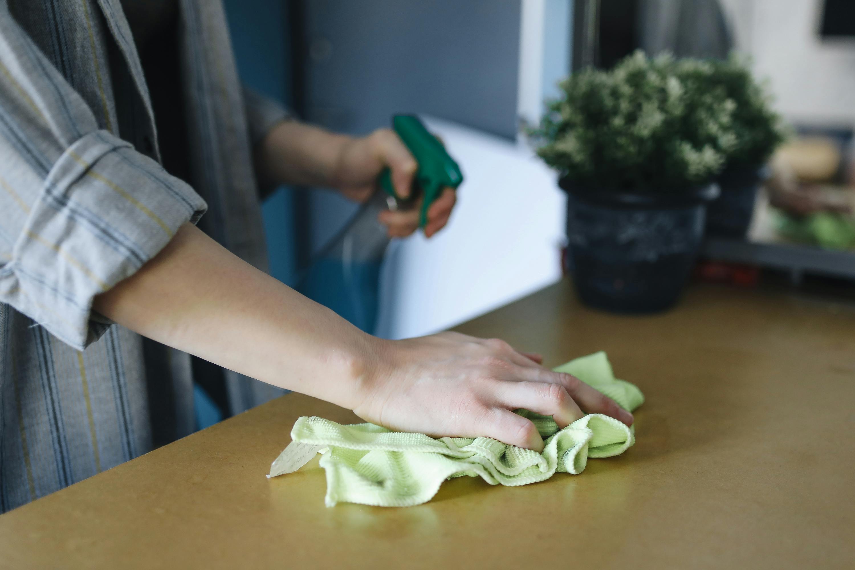 A woman wiping her table | Source: Pexels