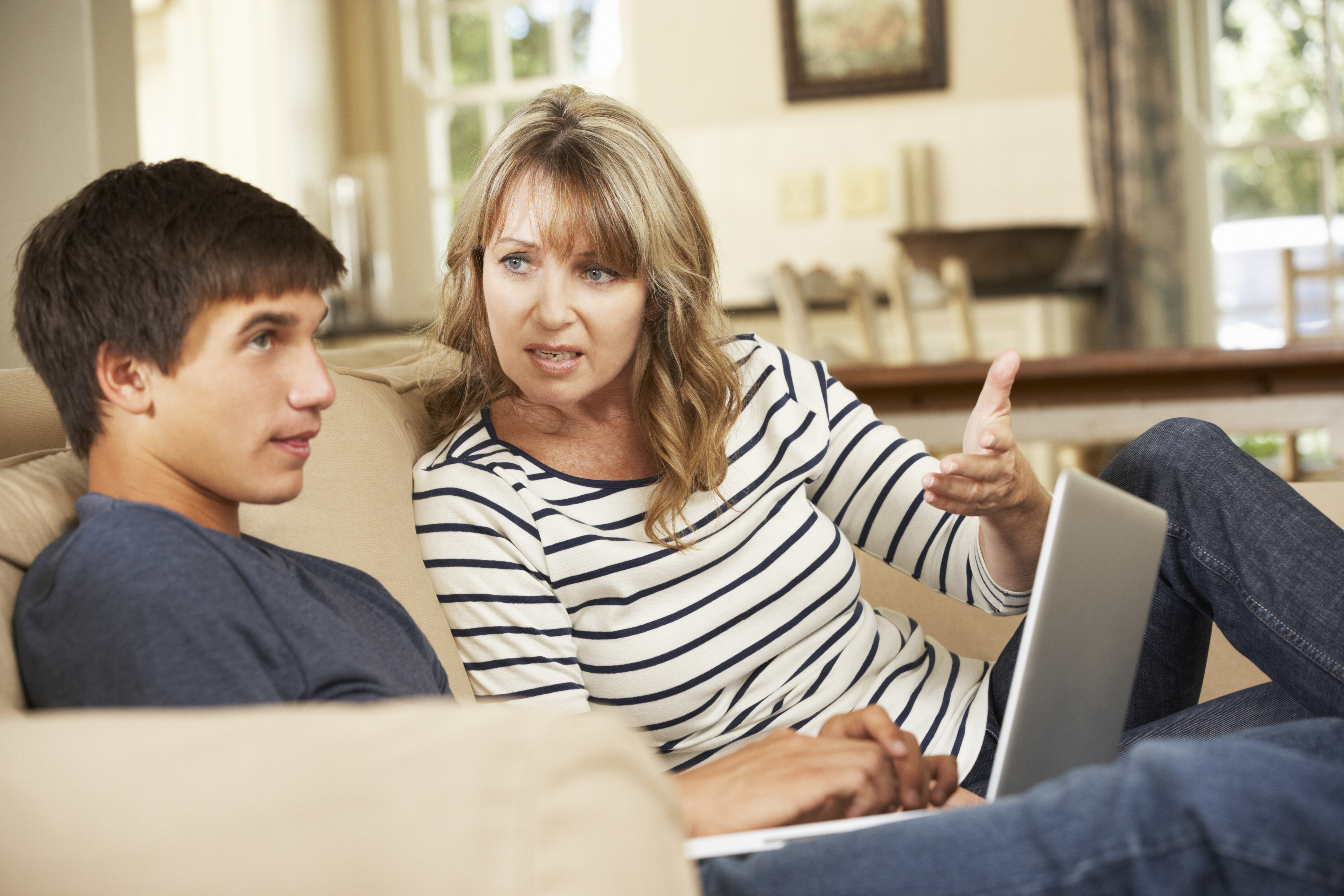 A teenager and mother auguring | Source: Shutterstock