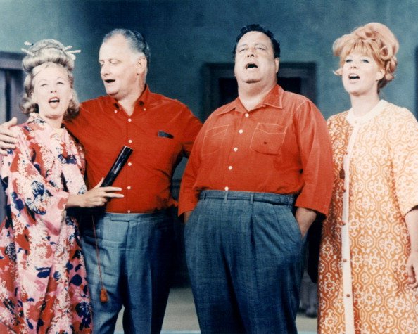 Joyce Randolph, Art Carney, Jackie Gleason, and Audrey Meadows stand in a group singing in an image issued publicity for the television series, "The Honeymooners," circa 1955. | Photo: Getty Images