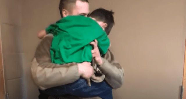 Army Private Second Class Brett Beaver hugs his little brother Max in school. | Source:  youtube.com/mlive