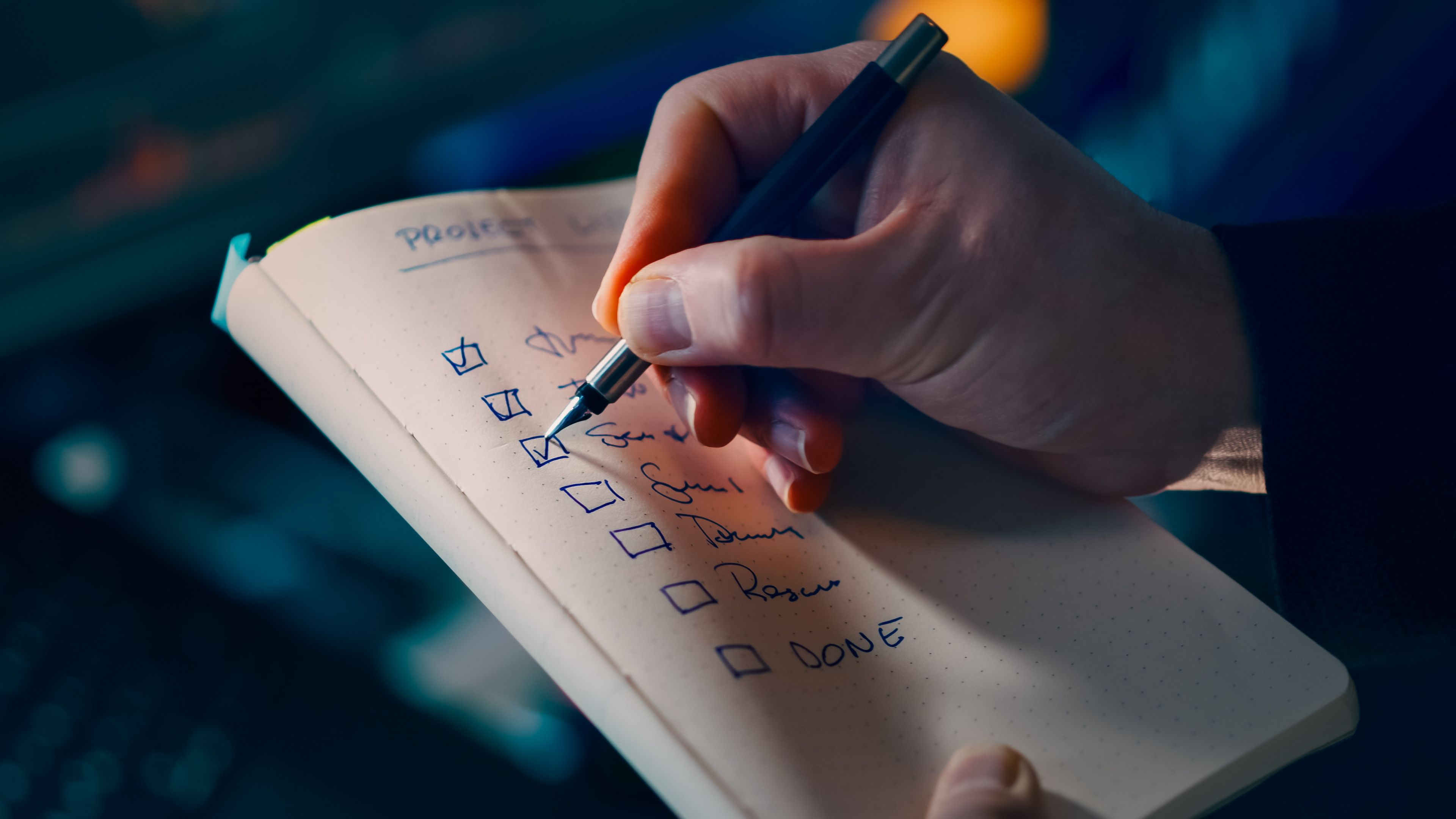 Person ticking a priority list | Source: Pexels