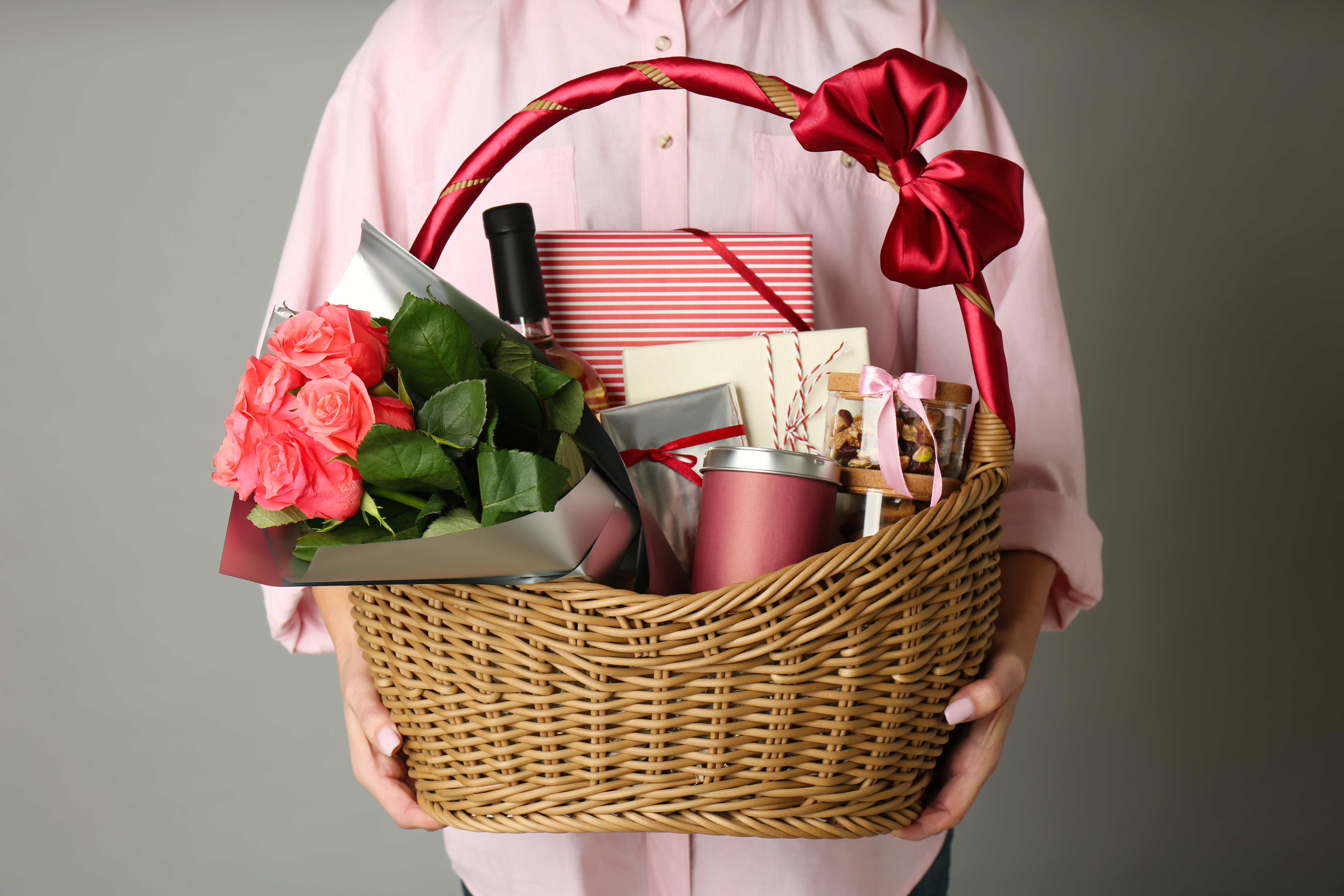 A woman holding a basket full of gifts | Source: Shutterstock