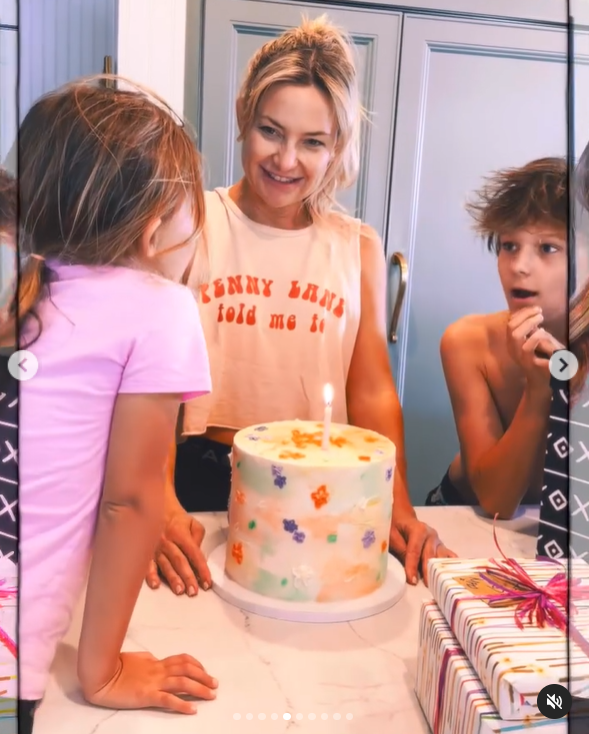 Kate Hudson smiles before she blows her birthday cake pictured in April 2024. | Source: Instagram/katehudson