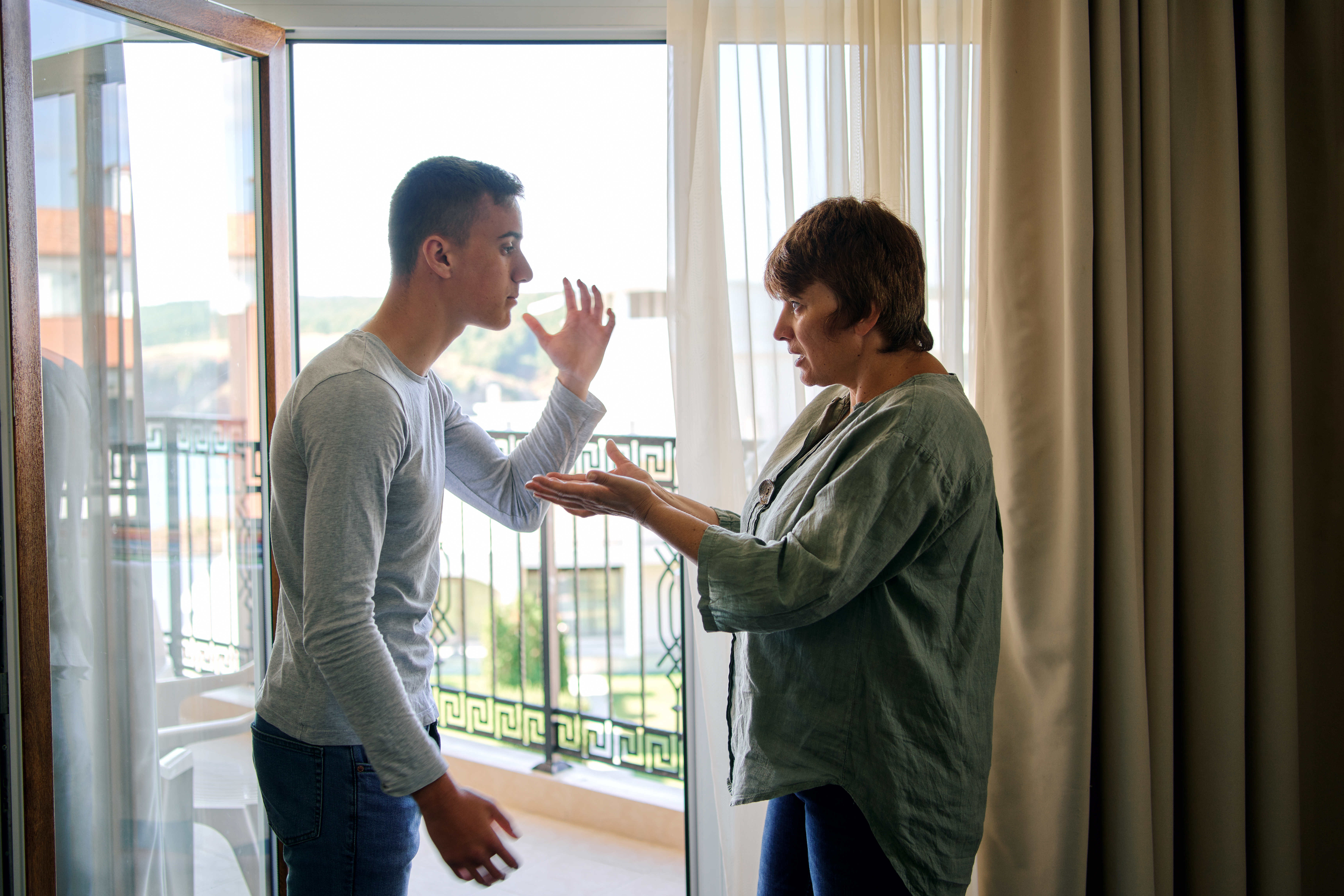 A young man arguing with his mother | Source: Shutterstock