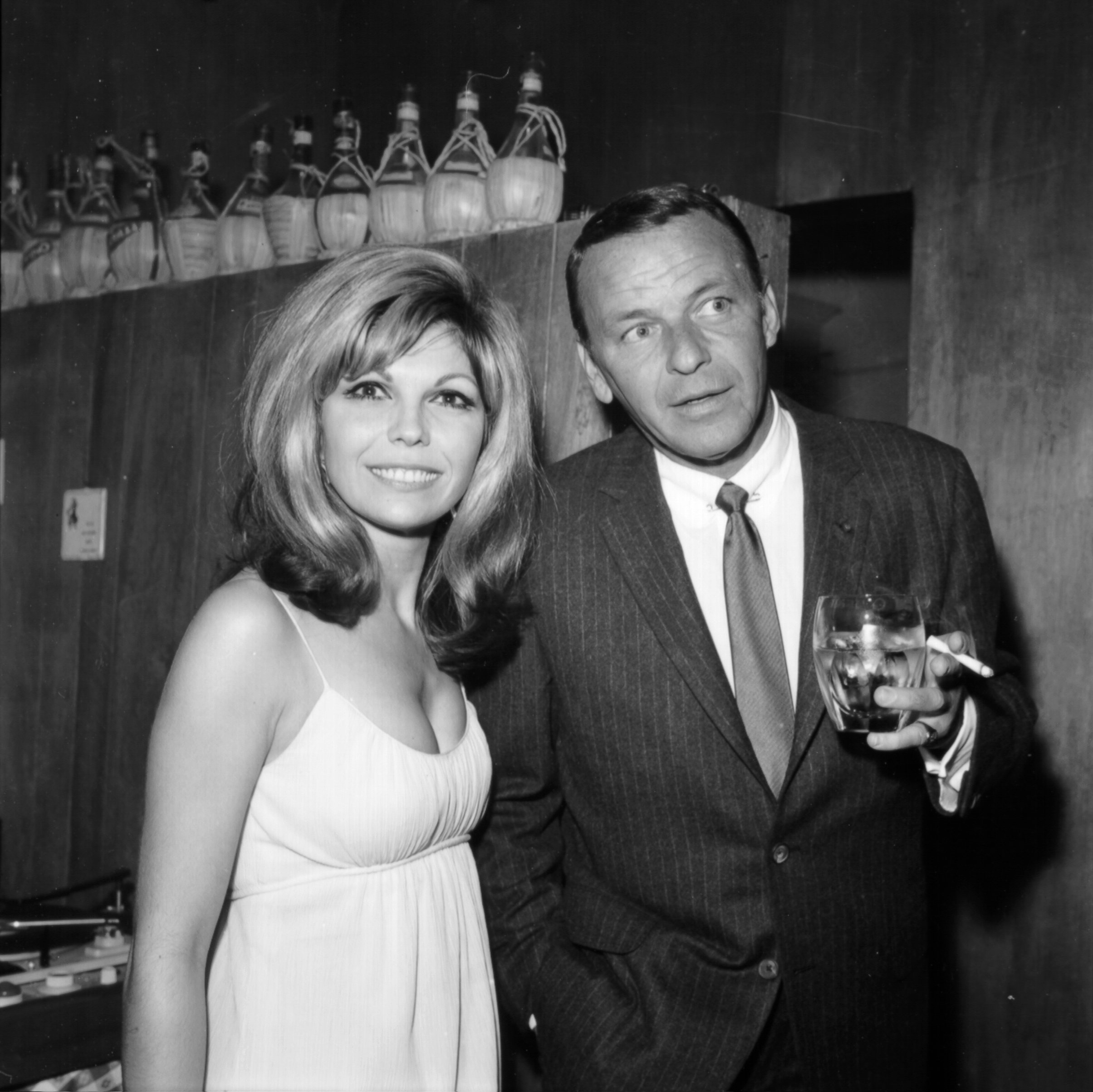 Pop singer Frank Sinatra enjoys a cocktail at an event with his daughter singer Nancy Sinatra in circa 1967 | Photo: Getty Images