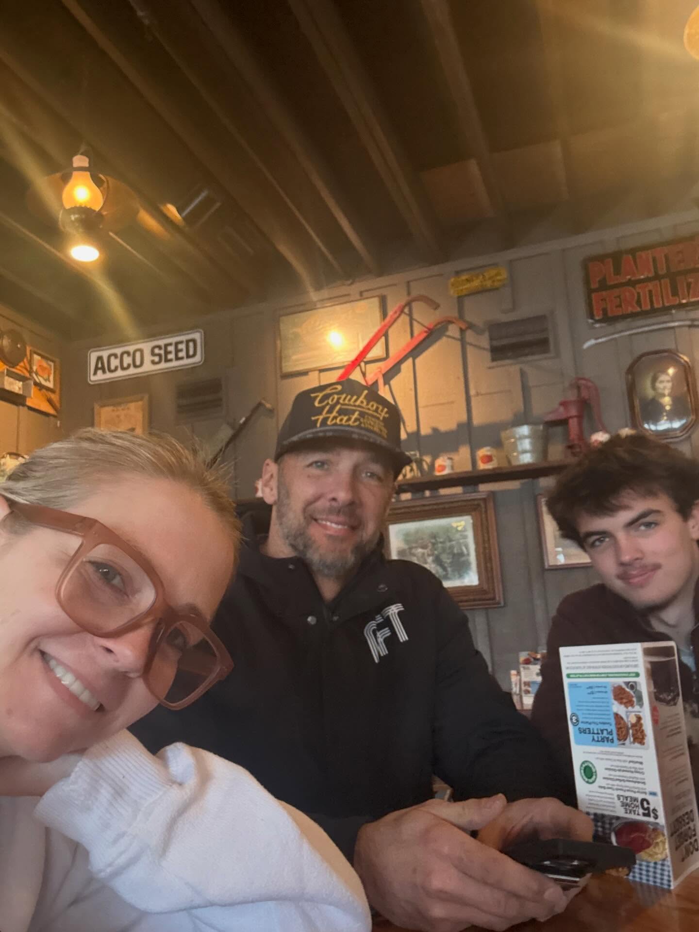 Melissa Joan Hart, Mark Wilkerson, and Brady Wilkerson in a restaurant, from a post dated January 28, 2026 | Source: Facebook/Melissa Joan Hart