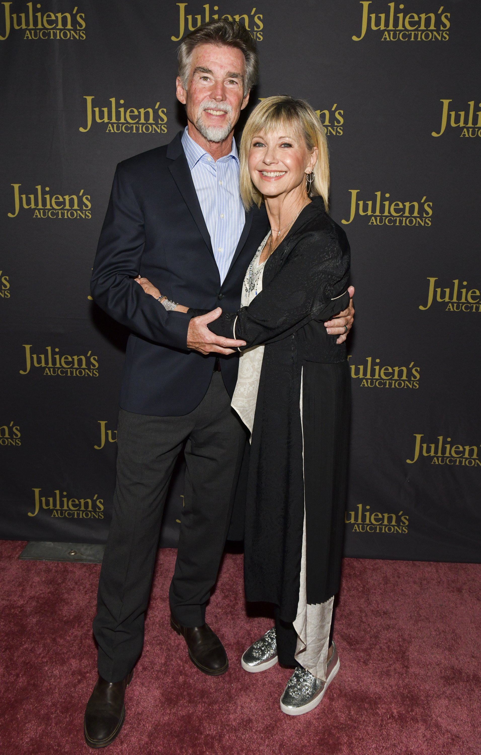 Olivia Newton-John (R) and John Easterling attend the VIP reception for upcoming "Property of Olivia Newton-John Auction Event at Julien’s Auctions on October 29, 2019 in Beverly Hills, California. | Source: Getty Images
