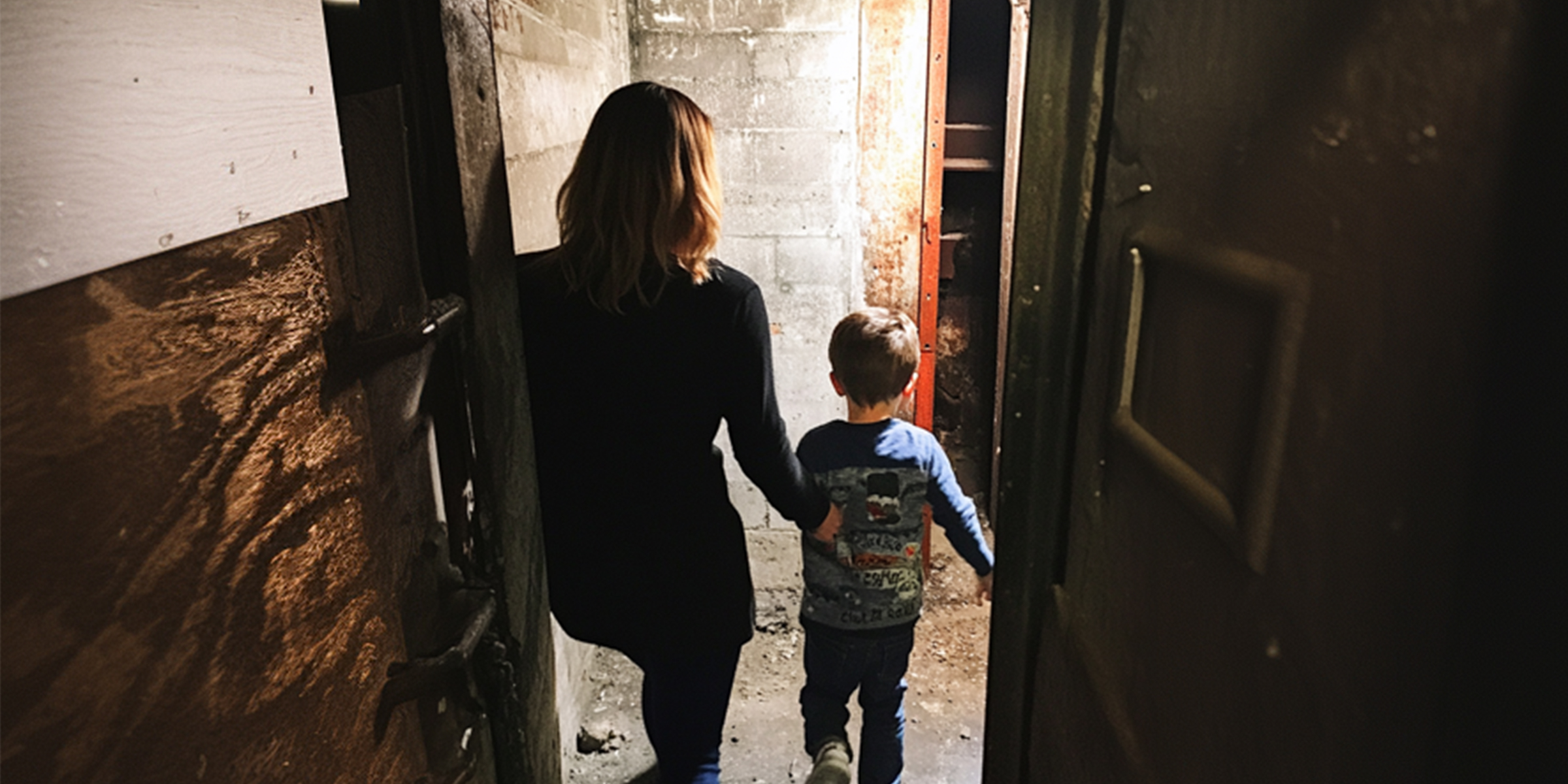 A woman and a little boy in a basement | Source: Amomama