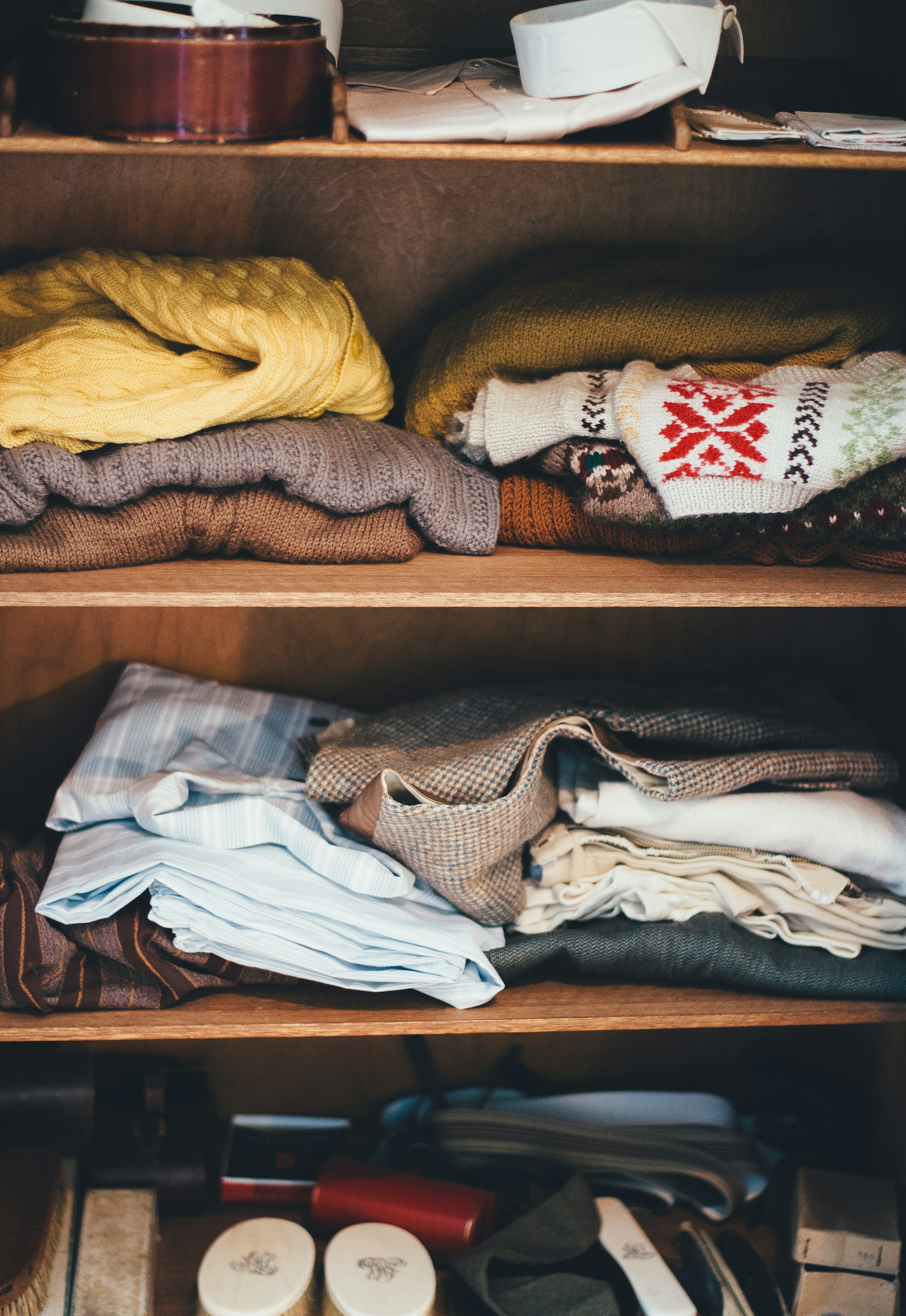 Clothing on a shelf in a cupboard | Source: Unsplash