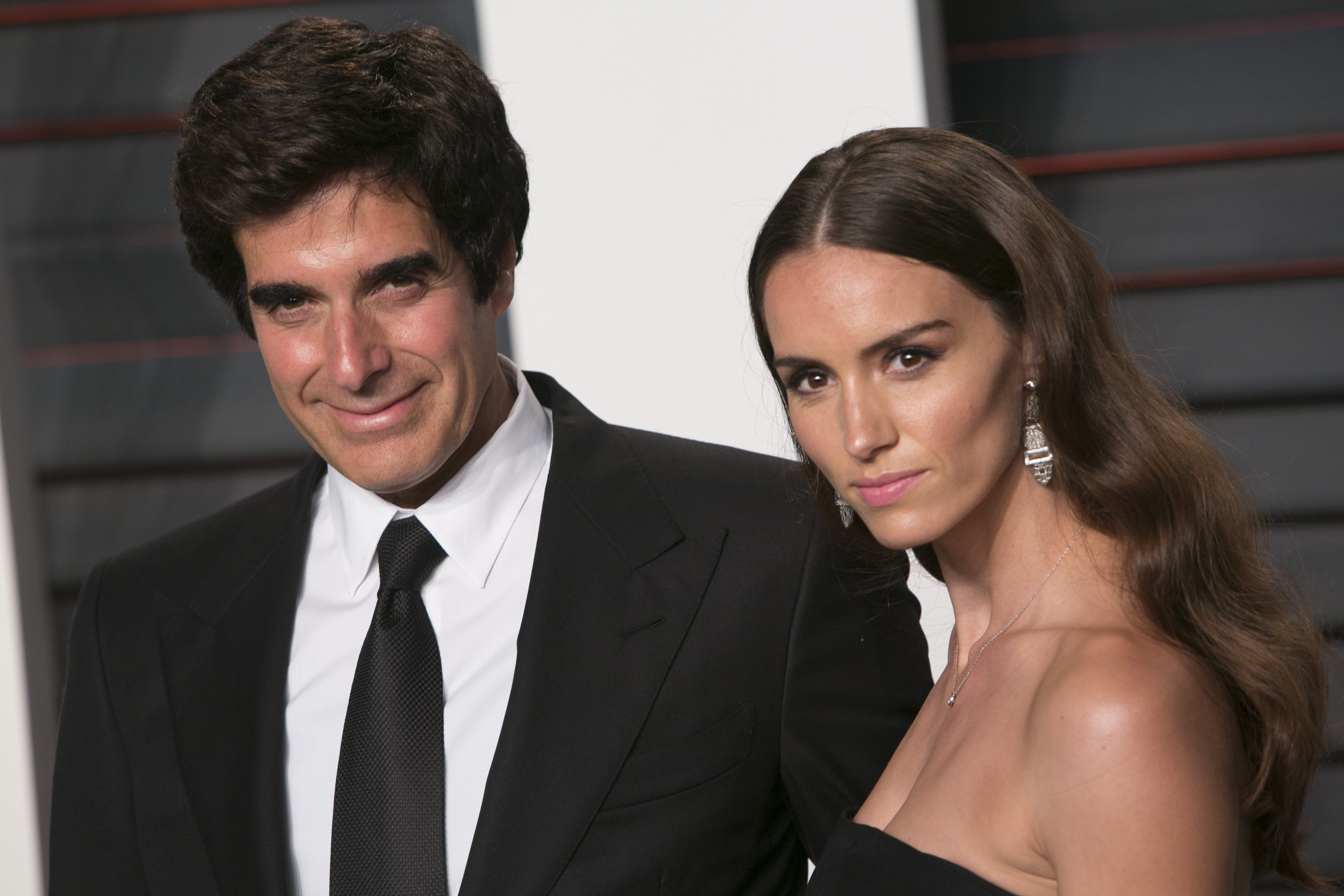 David Copperfield and Chloe Gosselin pose as they arrive at the 2016 Vanity Fair Oscar Party in Beverly Hills, California, on February 28, 2016. | Source: Getty Images