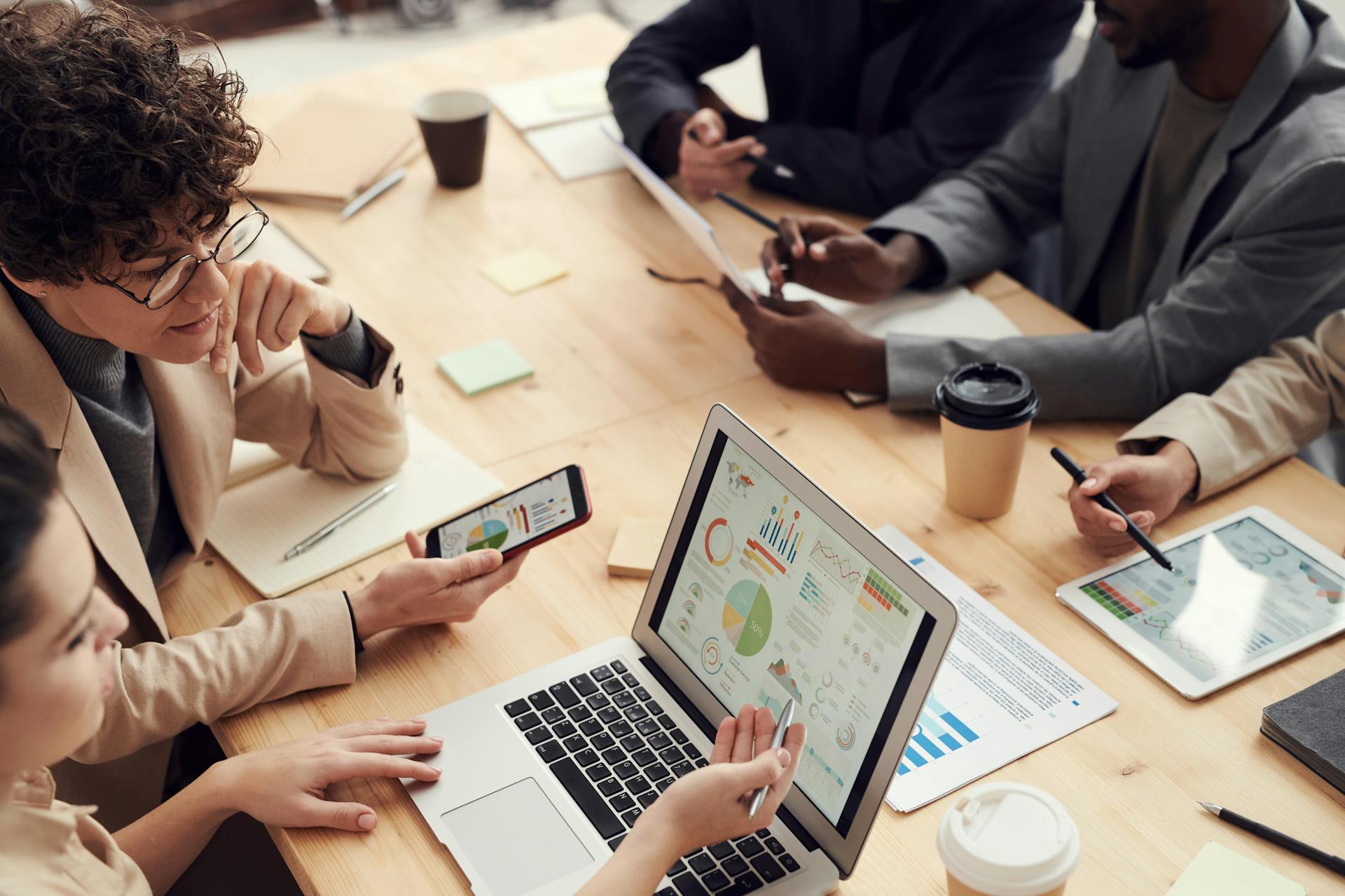 People discussing a presentation on a laptop | Source: Pexels