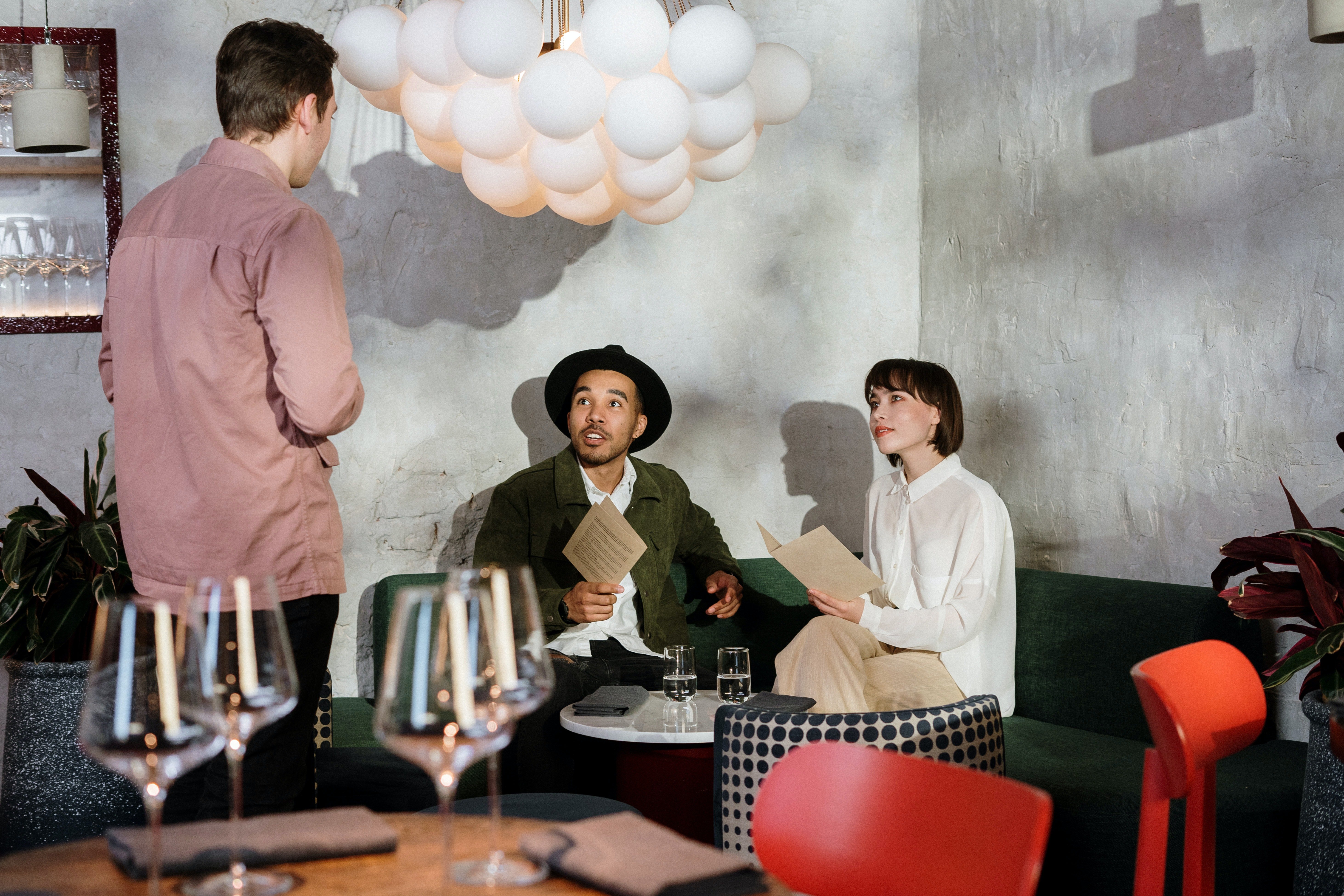 People listening to a man talk. | Photo: Pexels