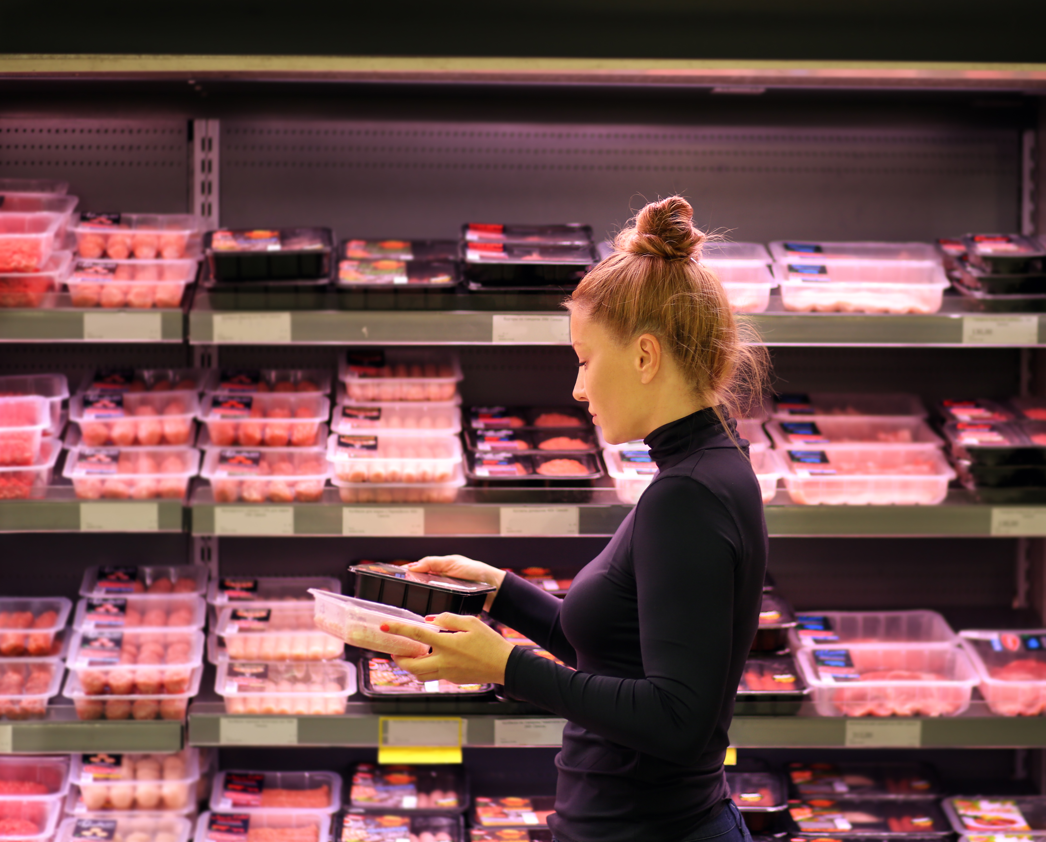 A woman shopping in the meat and poultry section in a grocery store | Source: Getty Images