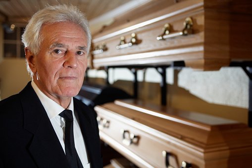 Photo of a man standing in a funeral parlor | Photo: Getty Images