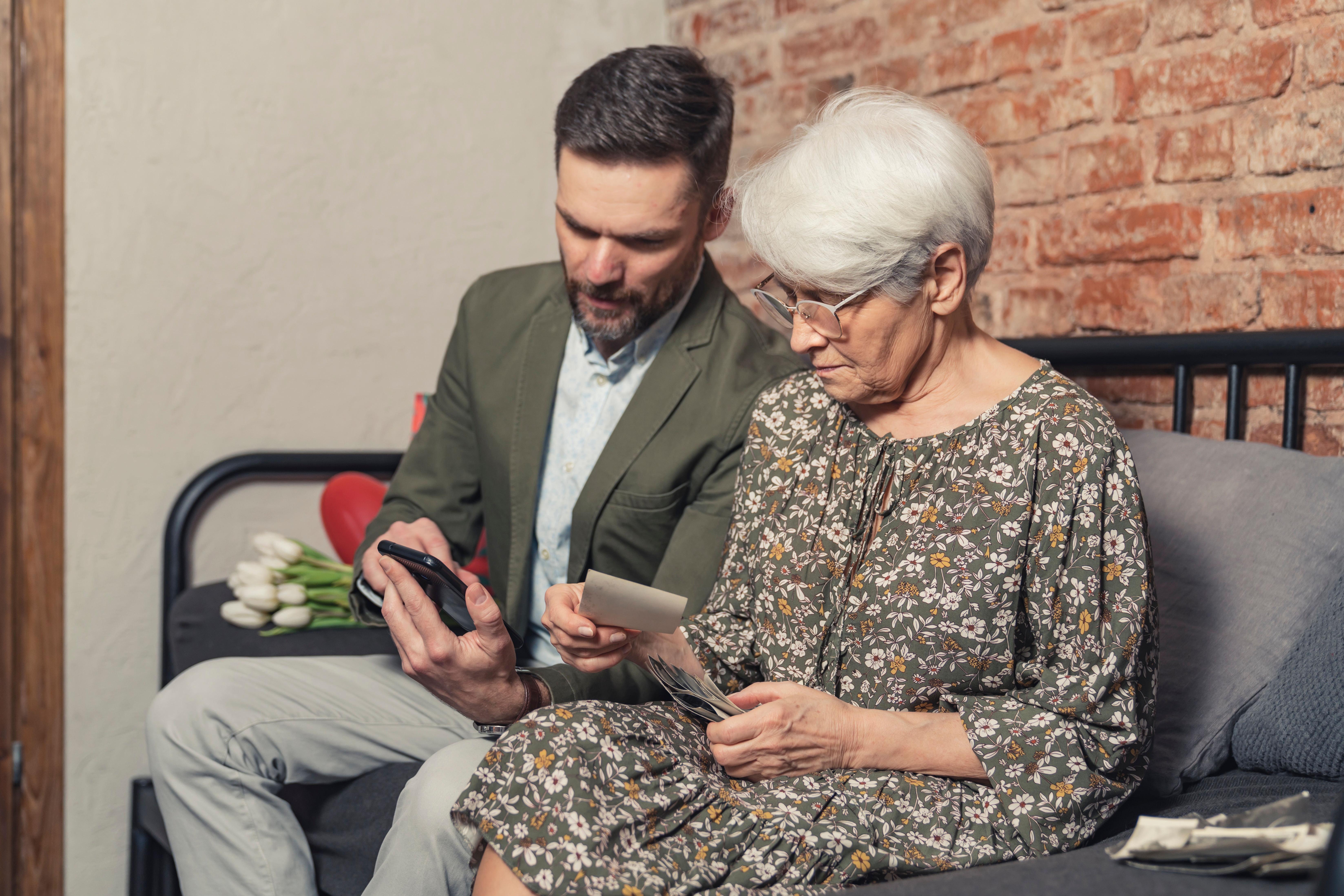 A man having a conversation with an elderly woman | Source: Shutterstock