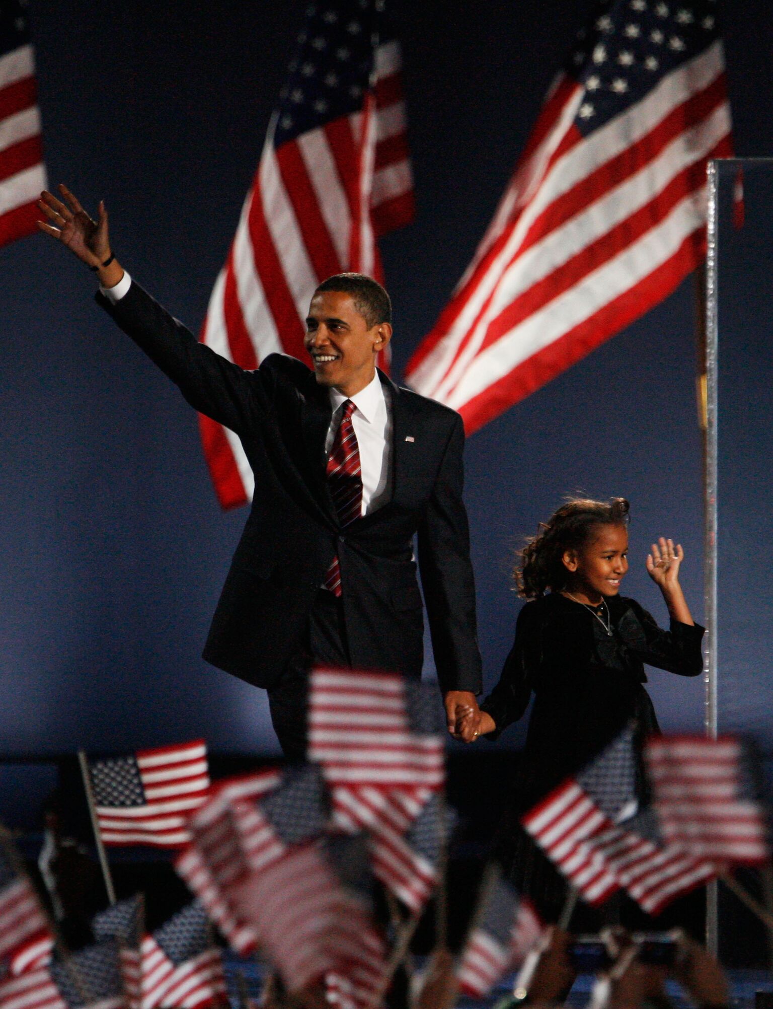 President elect Barack Obama and his daughter Sasha wave to Obama supporters during an election night gathering in Grant Park | Getty Images