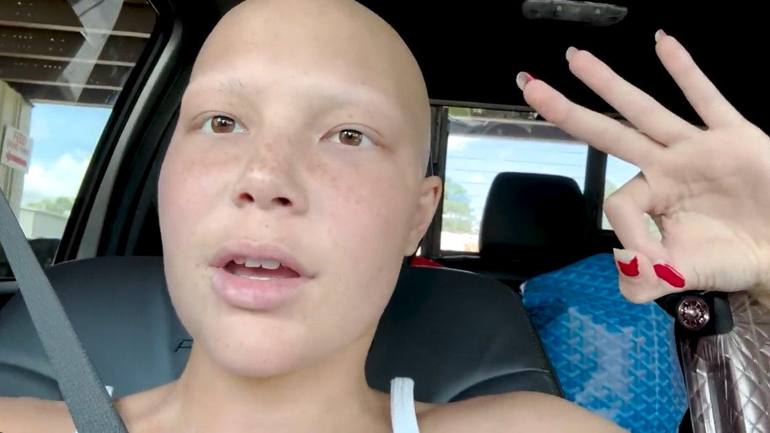 Isabella Strahan sits in a car and holds up her hand in an "okay" gesture, as posted on July 19, 2024 | Source: YouTube/IsabellaStrahan