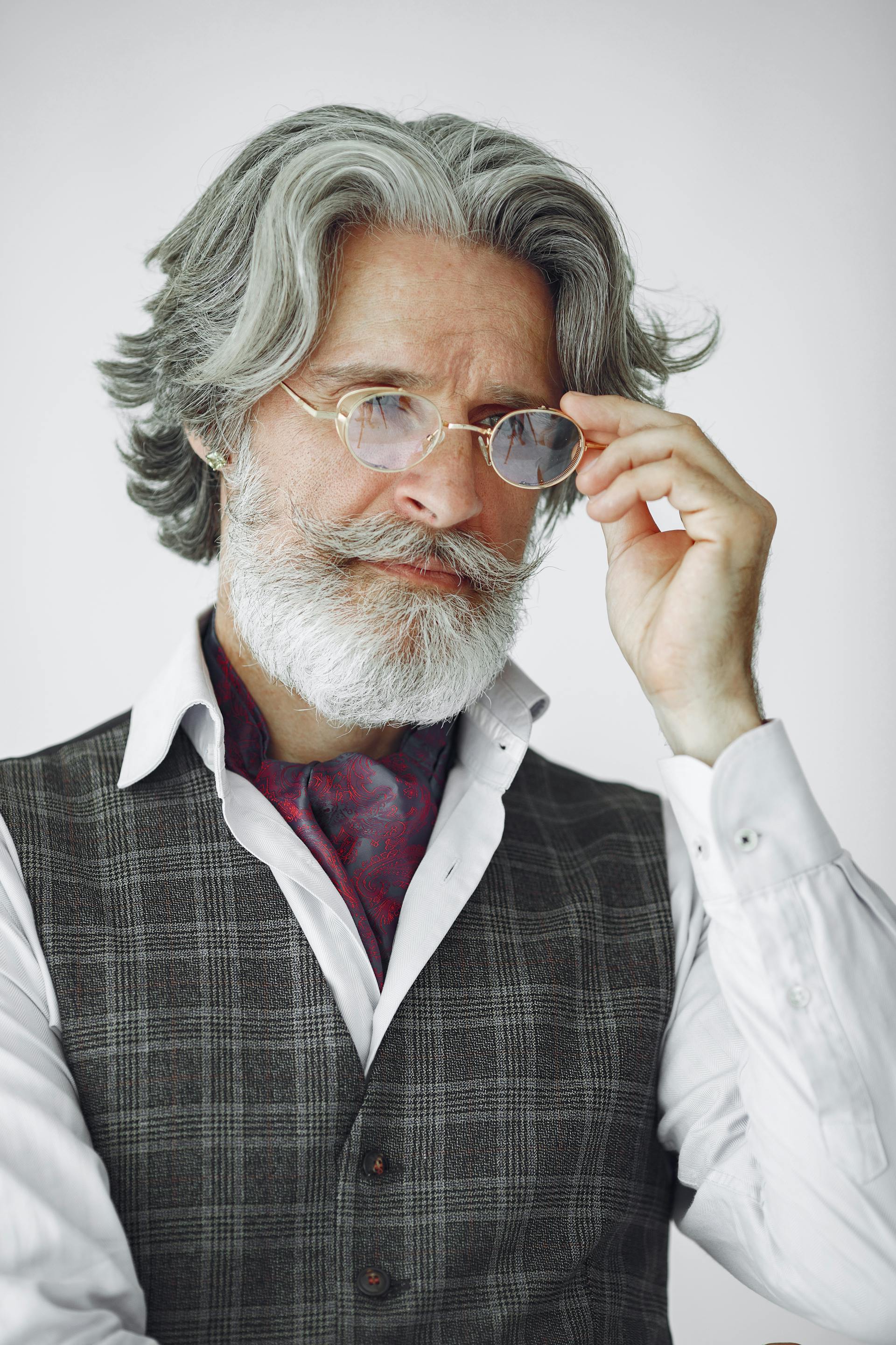 A thoughtful senior man holding his glasses | Source: Pexels