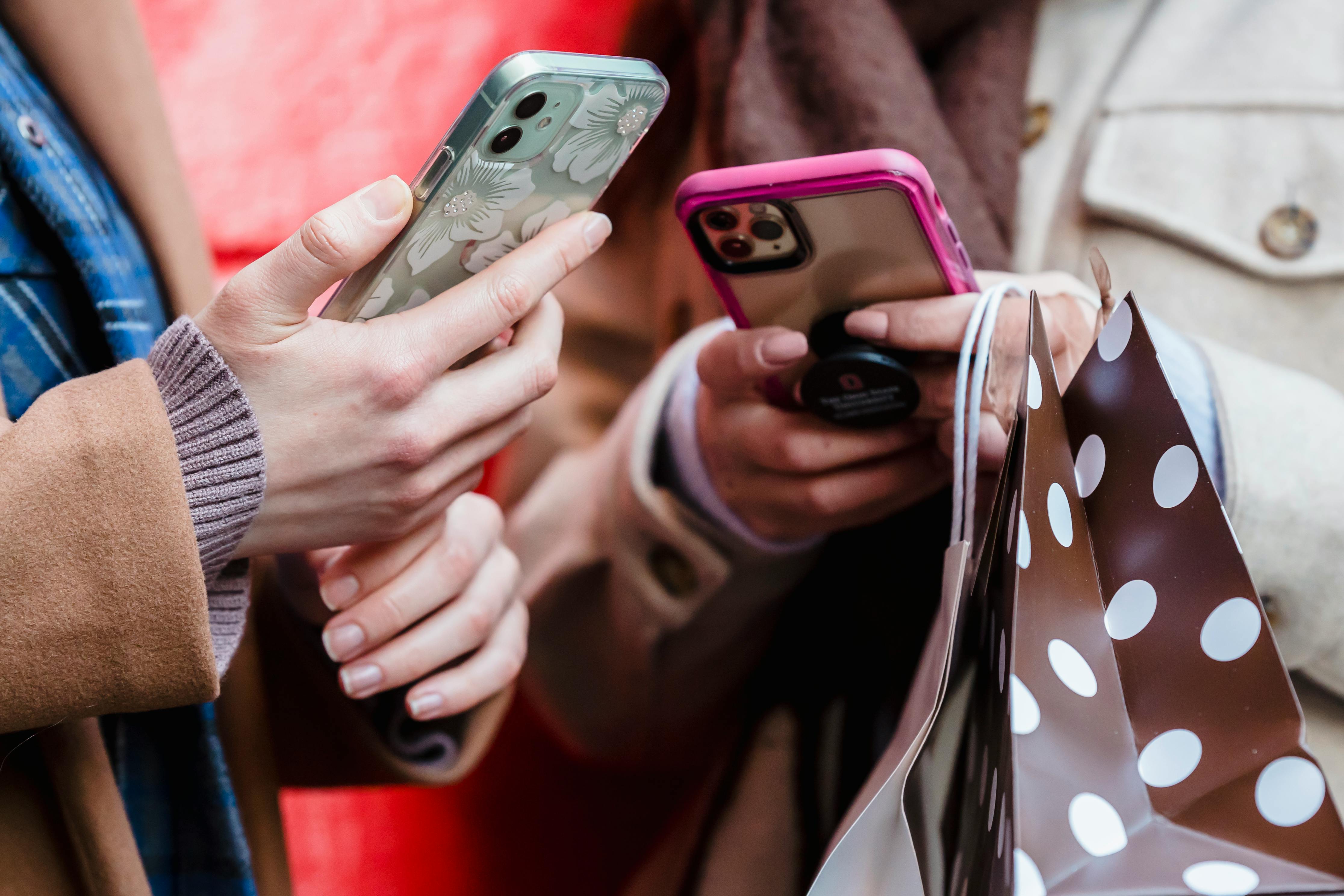 Two friends using their phones | Source: Pexels
