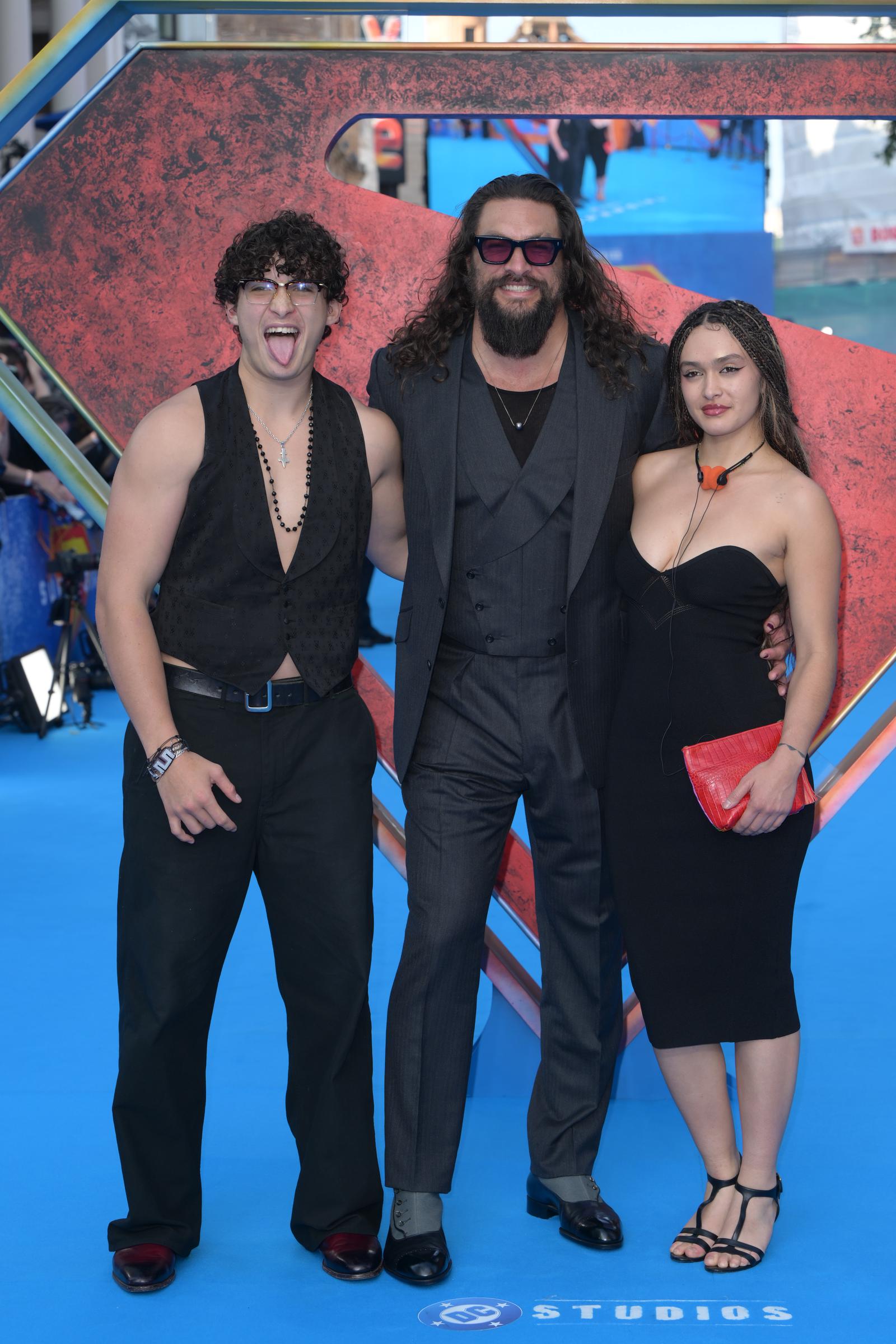 Jason Momoa attends the Supergirl fan event in London with his son, Nakoa-Wolf Momoa, and daughter, Lola Iolani Momoa, on June 18, 2026. After photos from the evening surfaced online, many viewers focused on Lola's resemblance to women who have played significant roles in her father's life. | Source: Getty Images