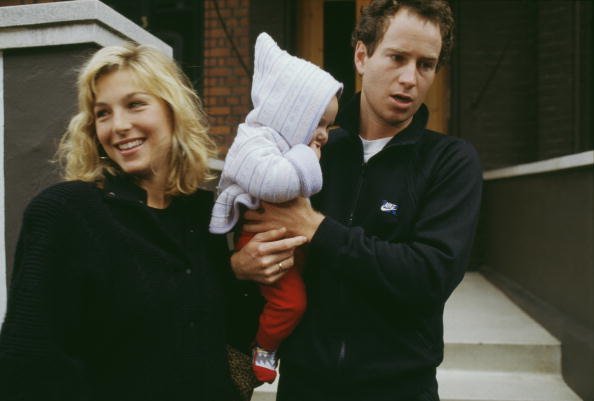 American tennis player John McEnroe with his wife, actress Tatum O'Neal, and one of their children, circa 1987. | Source: Getty Images.