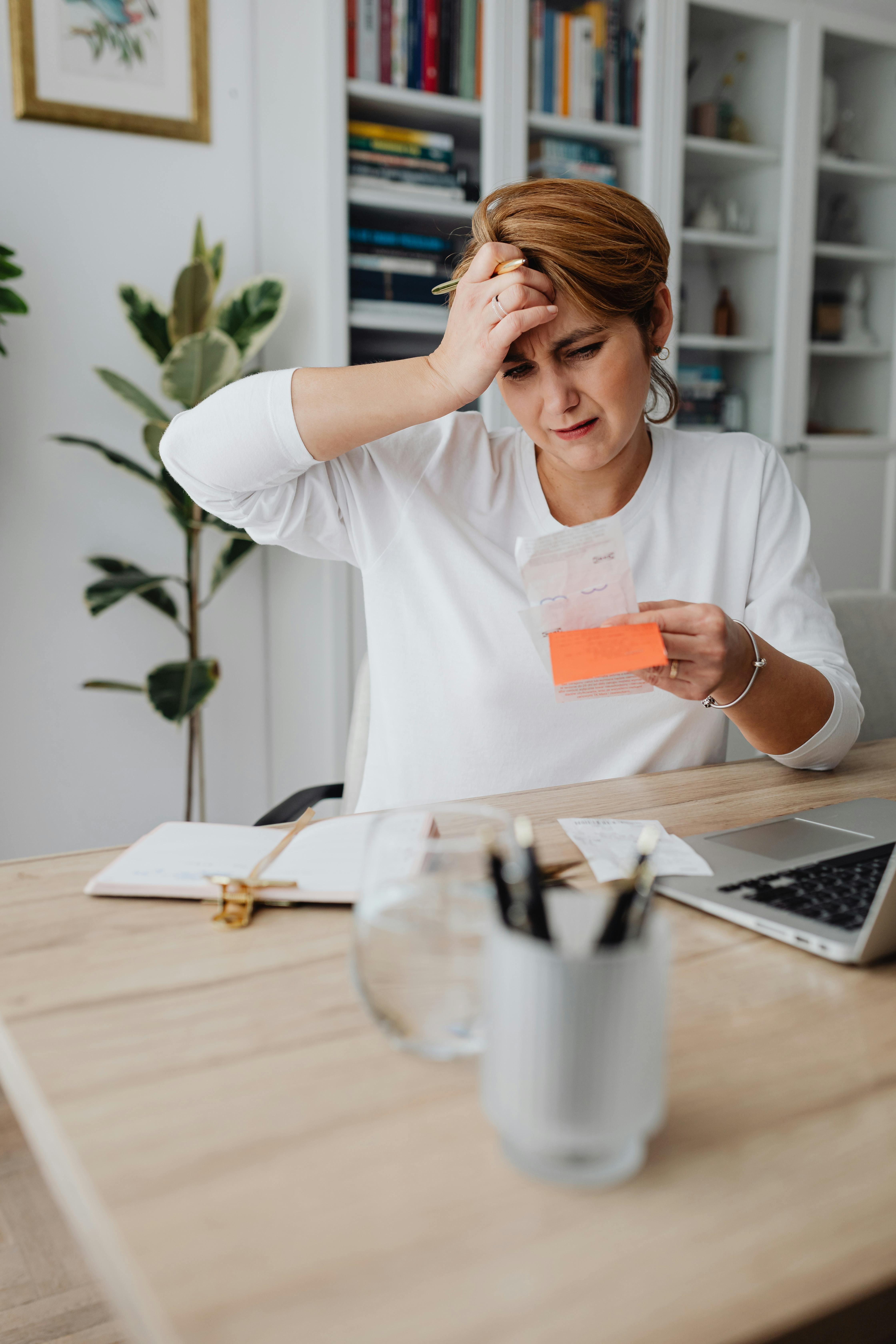 An upset woman looking at a receipt | Source: Pexels