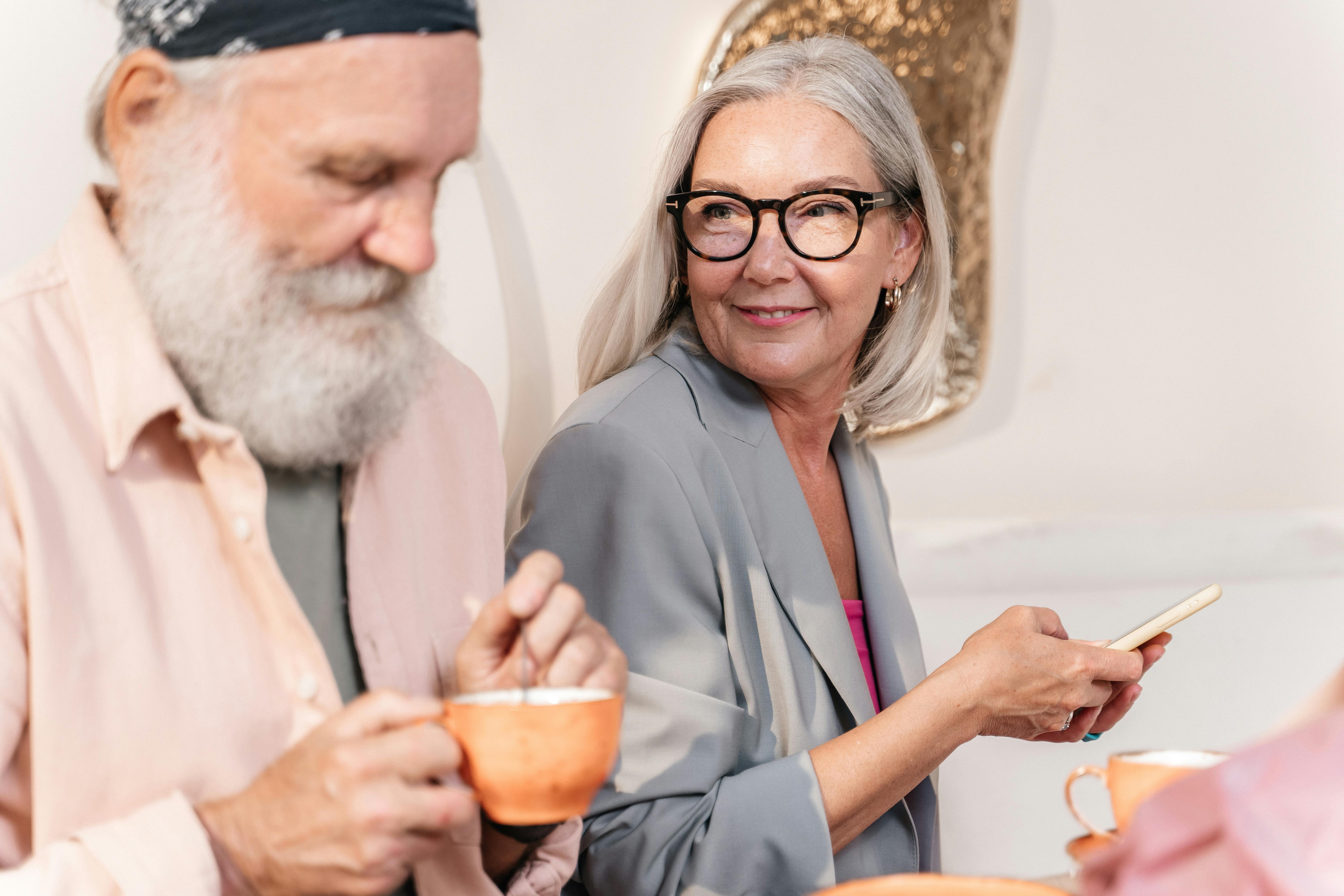 An elderly couple enjoying warm drinks | Source: Pexels