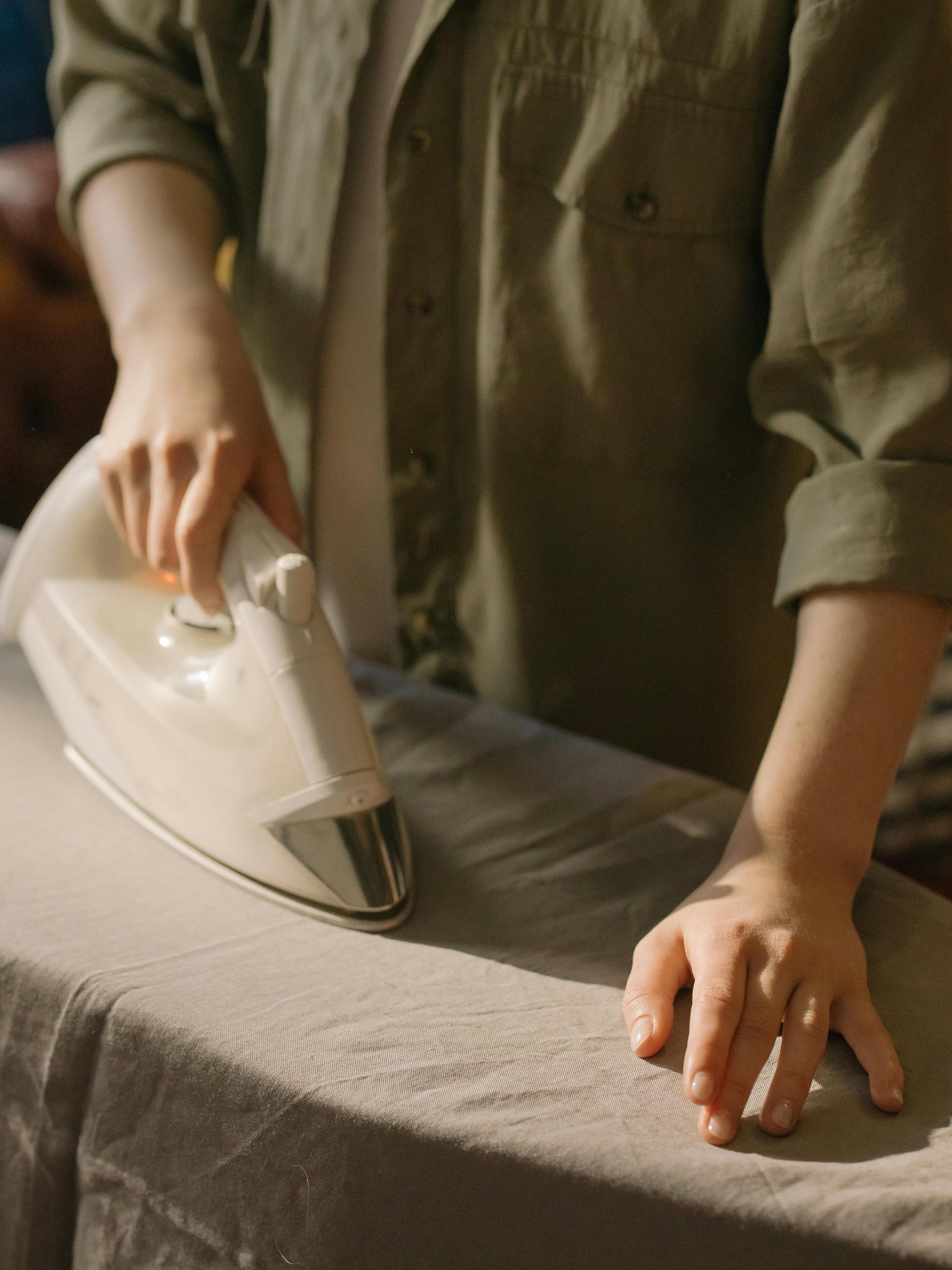 A woman ironing | Source: Pexels