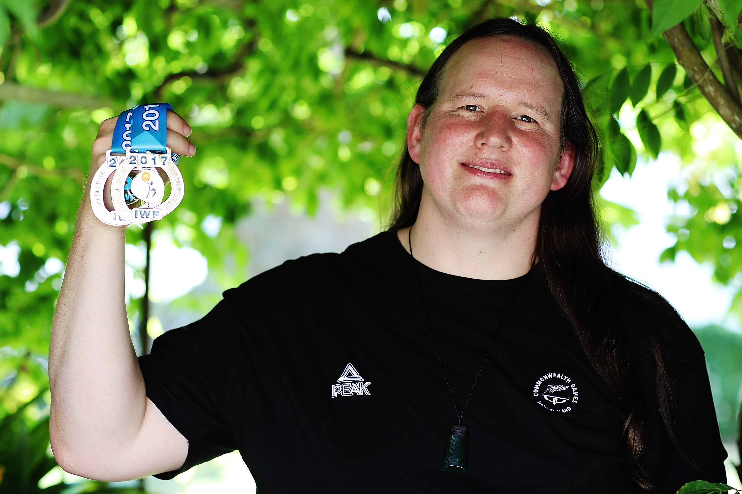 Transgender weightlifter Laurel Hubbard posing with two of her medals during a photoshoot in Auckland, New Zealand | Photo: Hannah Peters/Getty Images