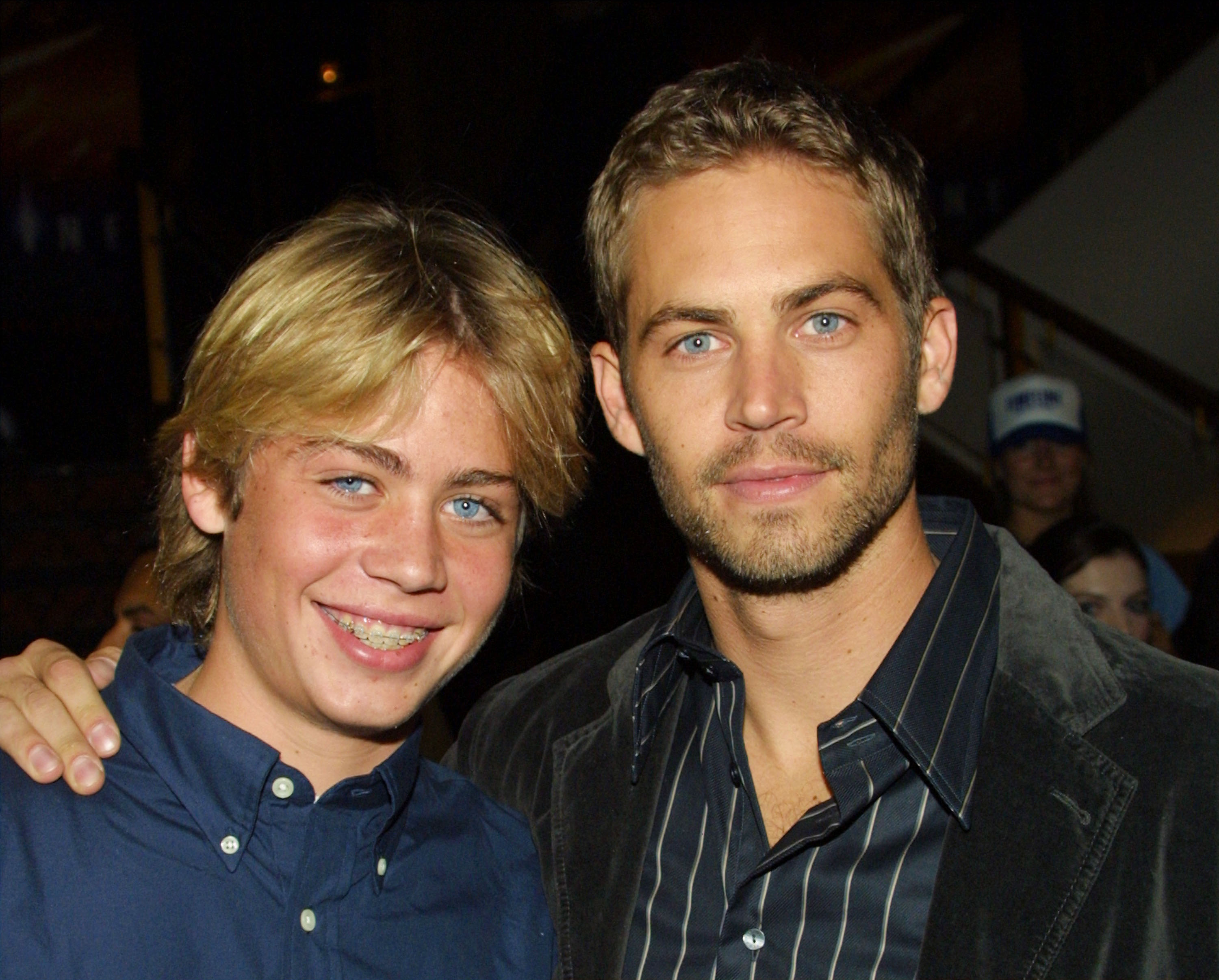 Cody Walker with his brother actor Paul Walker pose during the film premiere of "Timeline" at the Mann's National Theatre on November 19, 2003 in Westwood, California. | Source: Getty Images