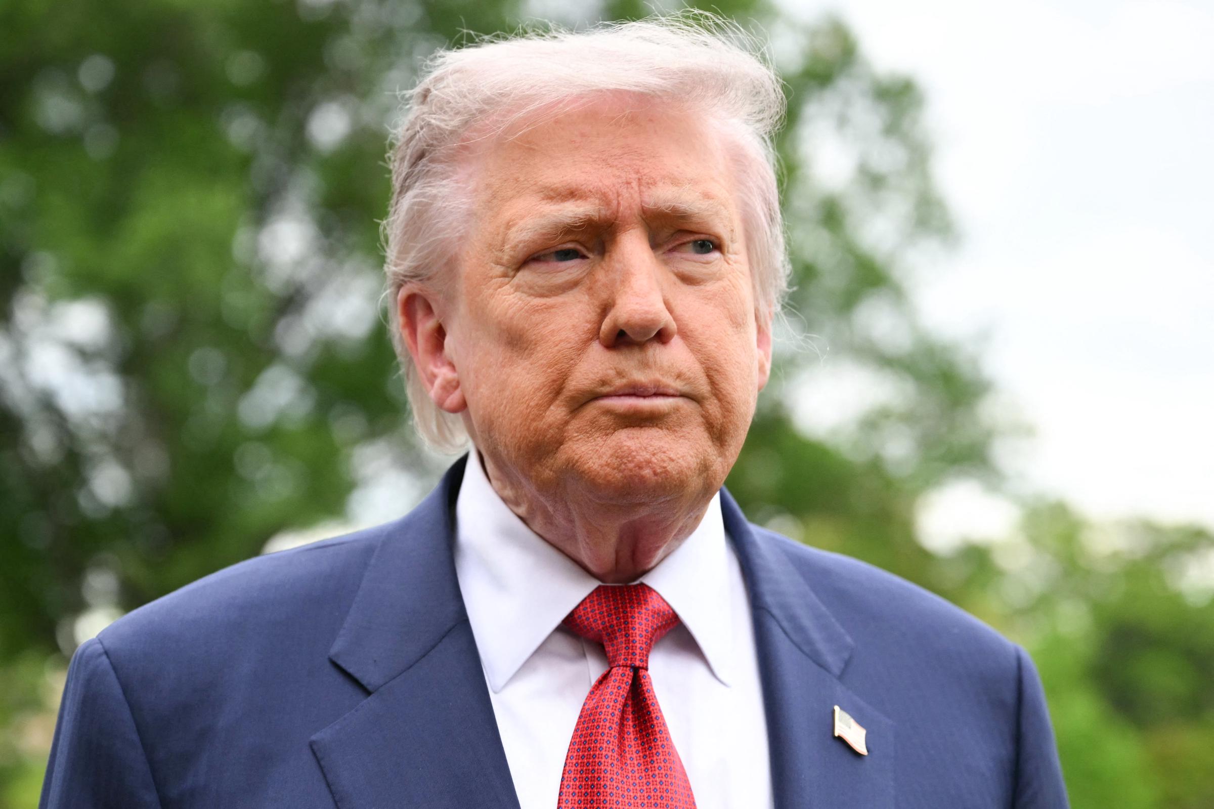 Donald Trump speaks to journalists as he makes his way to board Marine One before departing from the South Lawn of the White House in Washington, DC on May 8, 2026 | Source: Getty Images