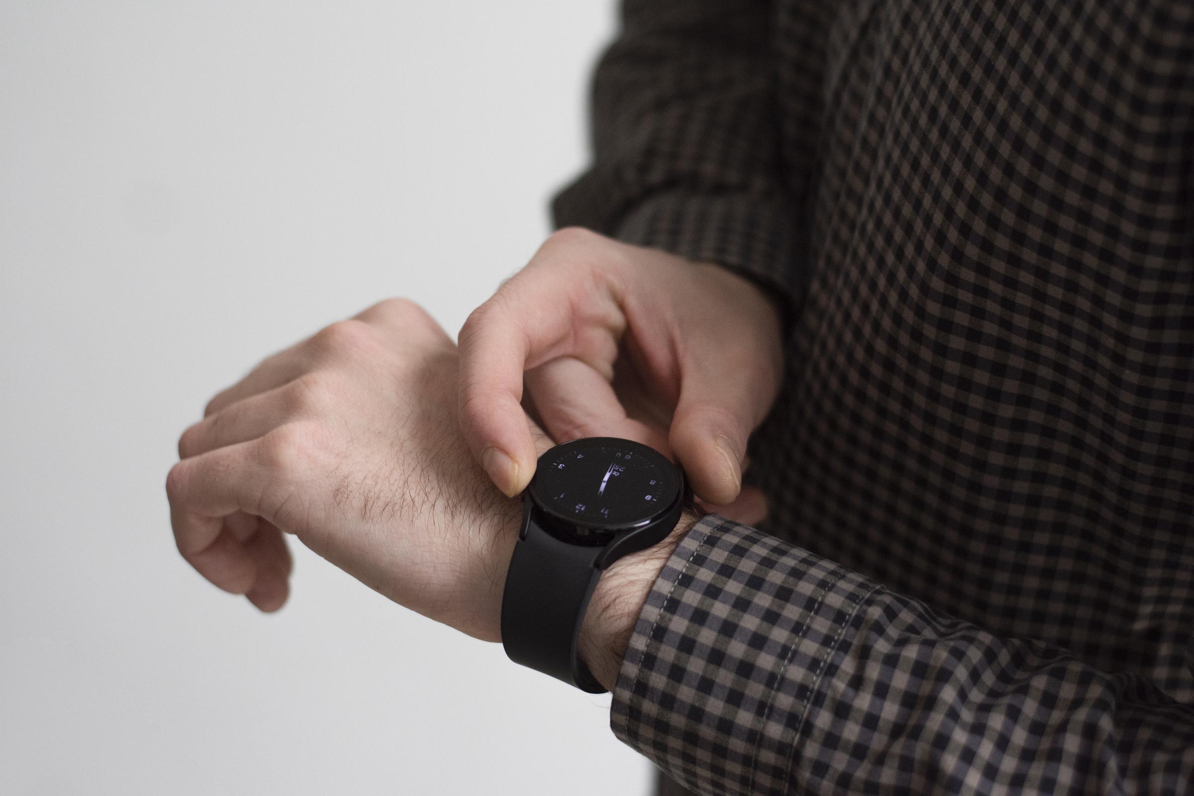 A man looking at his watch on his hand | Source: Freepik