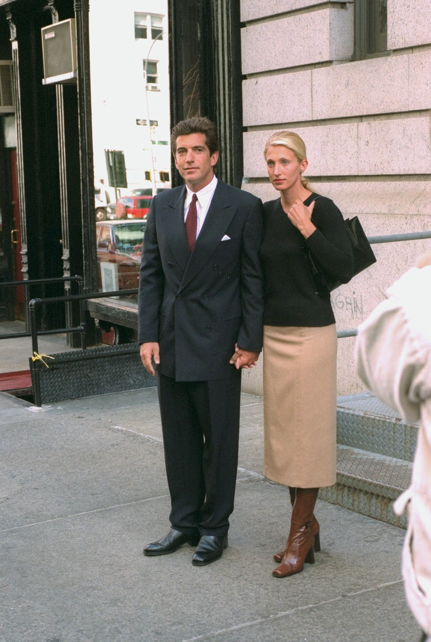 John F. Kennedy Jr. and bride Carolyn Bessette Kennedy standing in front of their apartment in Tribecca in October 1996 | Source: Getty Images