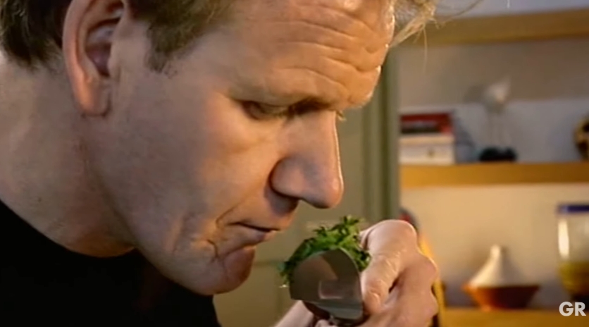 After finely slicing the basil, Gordon Ramsay lifts the herbs to check their aroma, highlighting how careful knife work keeps the fragrant oils locked inside the leaves instead of leaving them behind on the chopping board. | Source: YouTube/ Gordon Ramsay