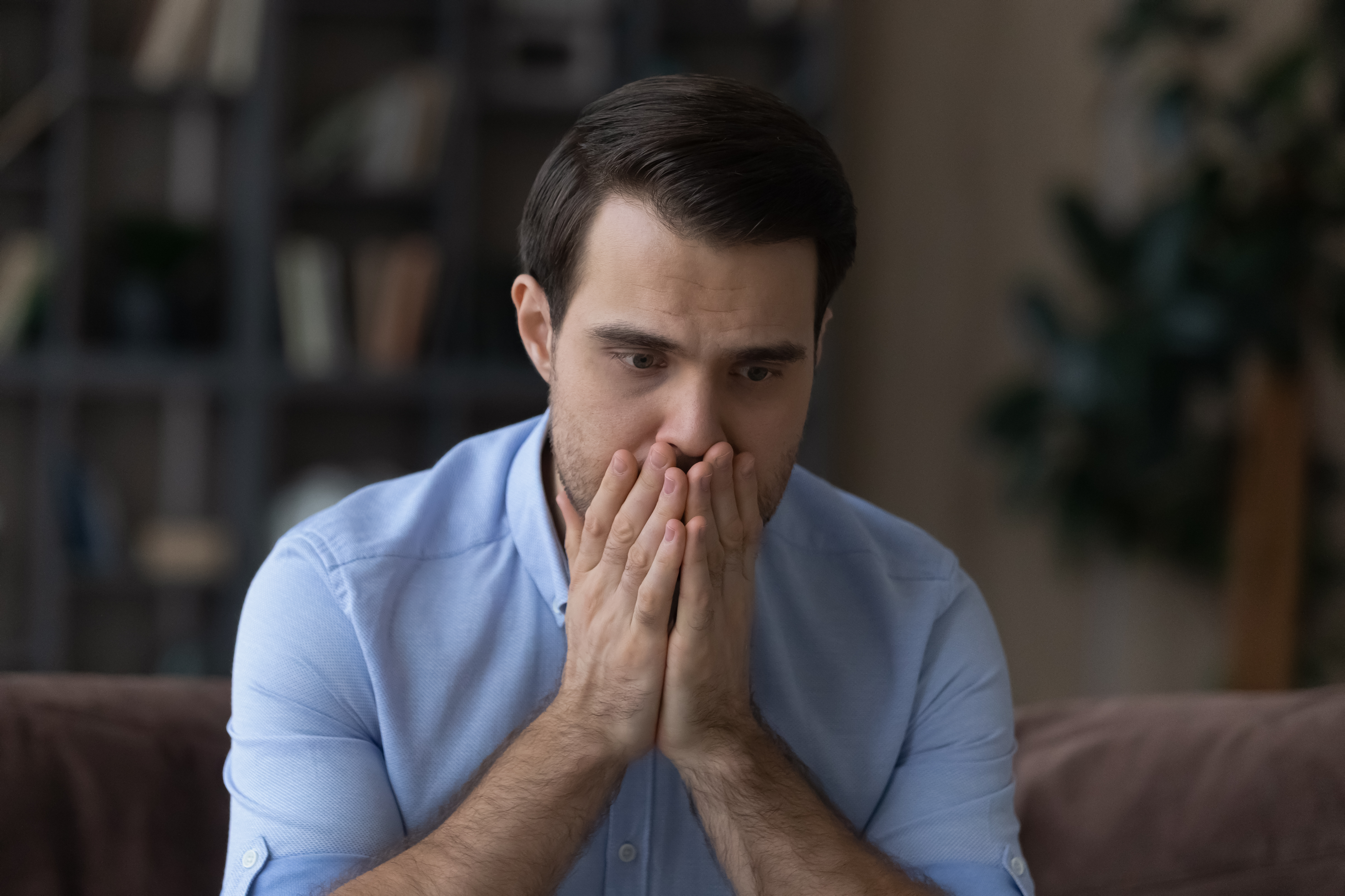 A man sitting with his hands on his mouth | Source: Pexels