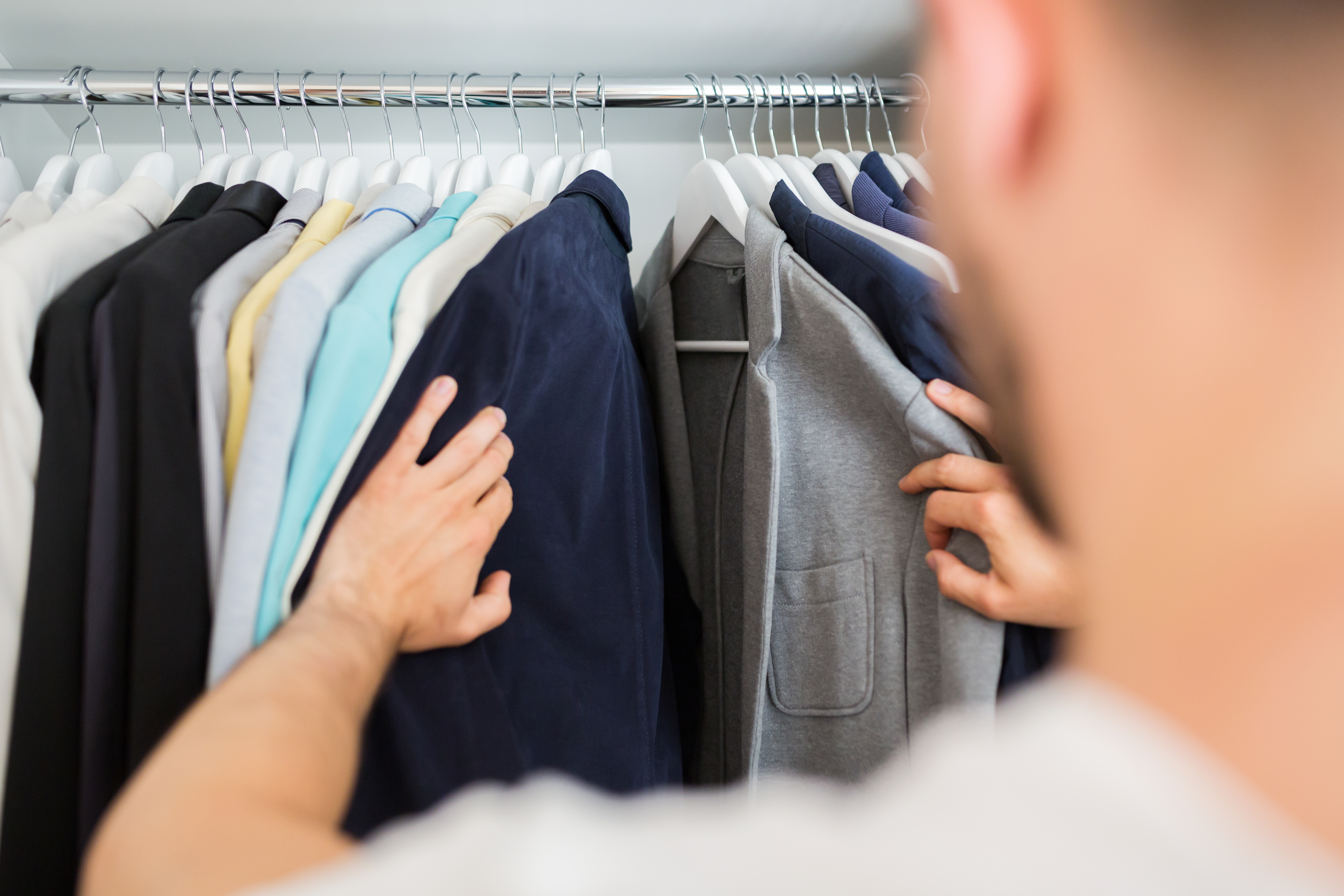 A man going through his closet | Source: Shutterstock
