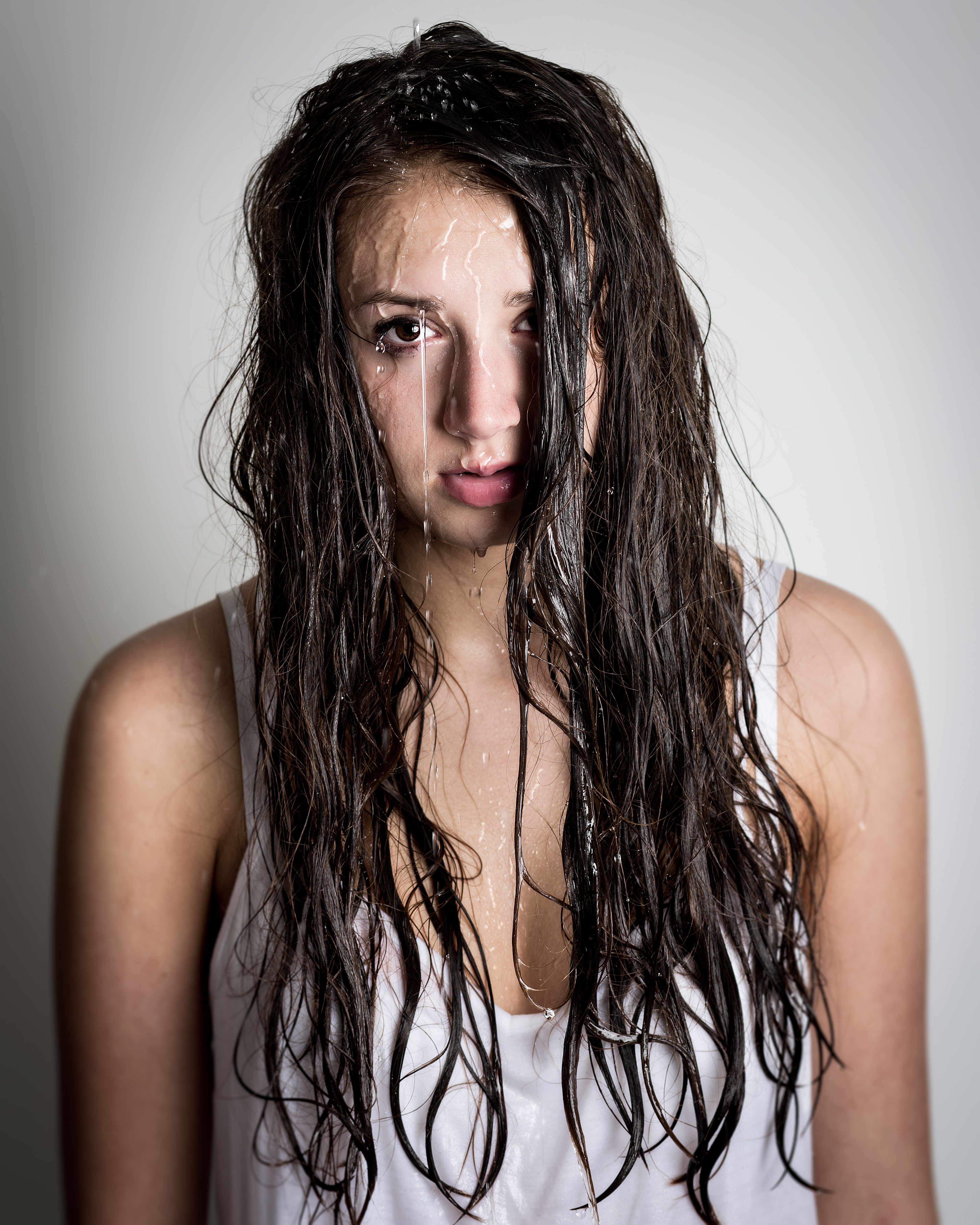 Teenage girl with water streaming down her face and hair | Source: Shutterstock.com