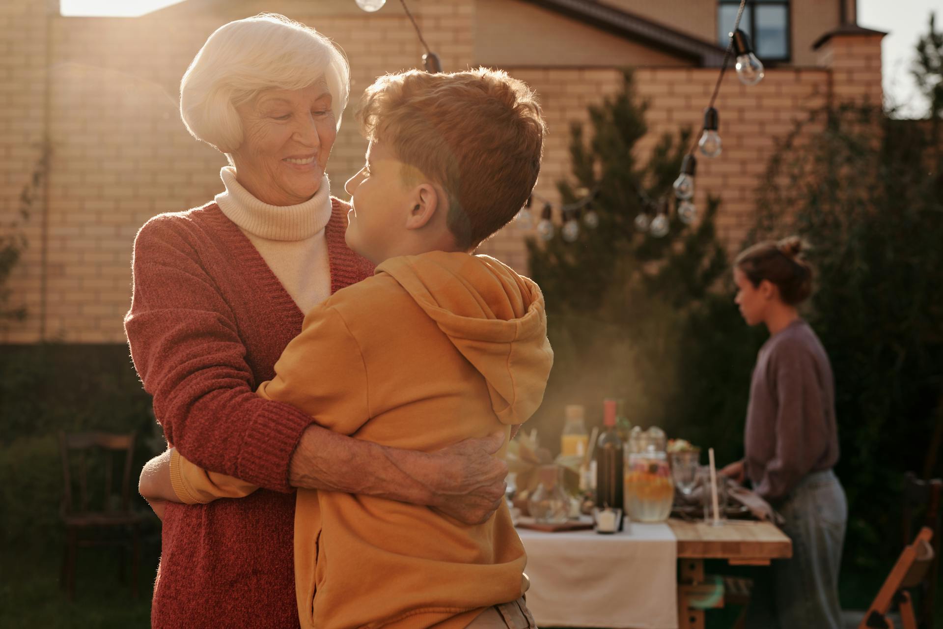 An elderly woman hugging her grandson | Source: Pexels
