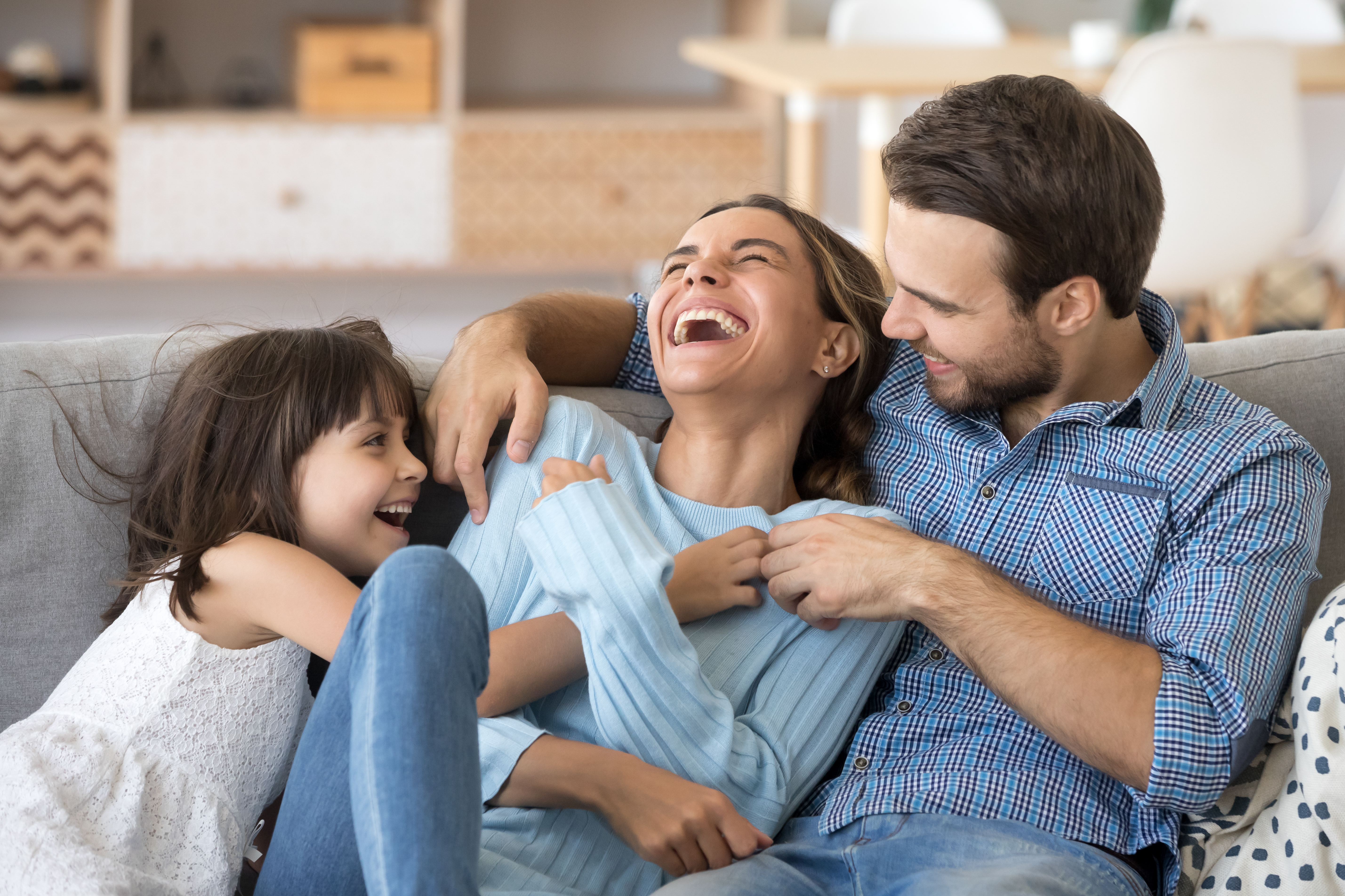 A couple playing with their daughter | Source: Shutterstock