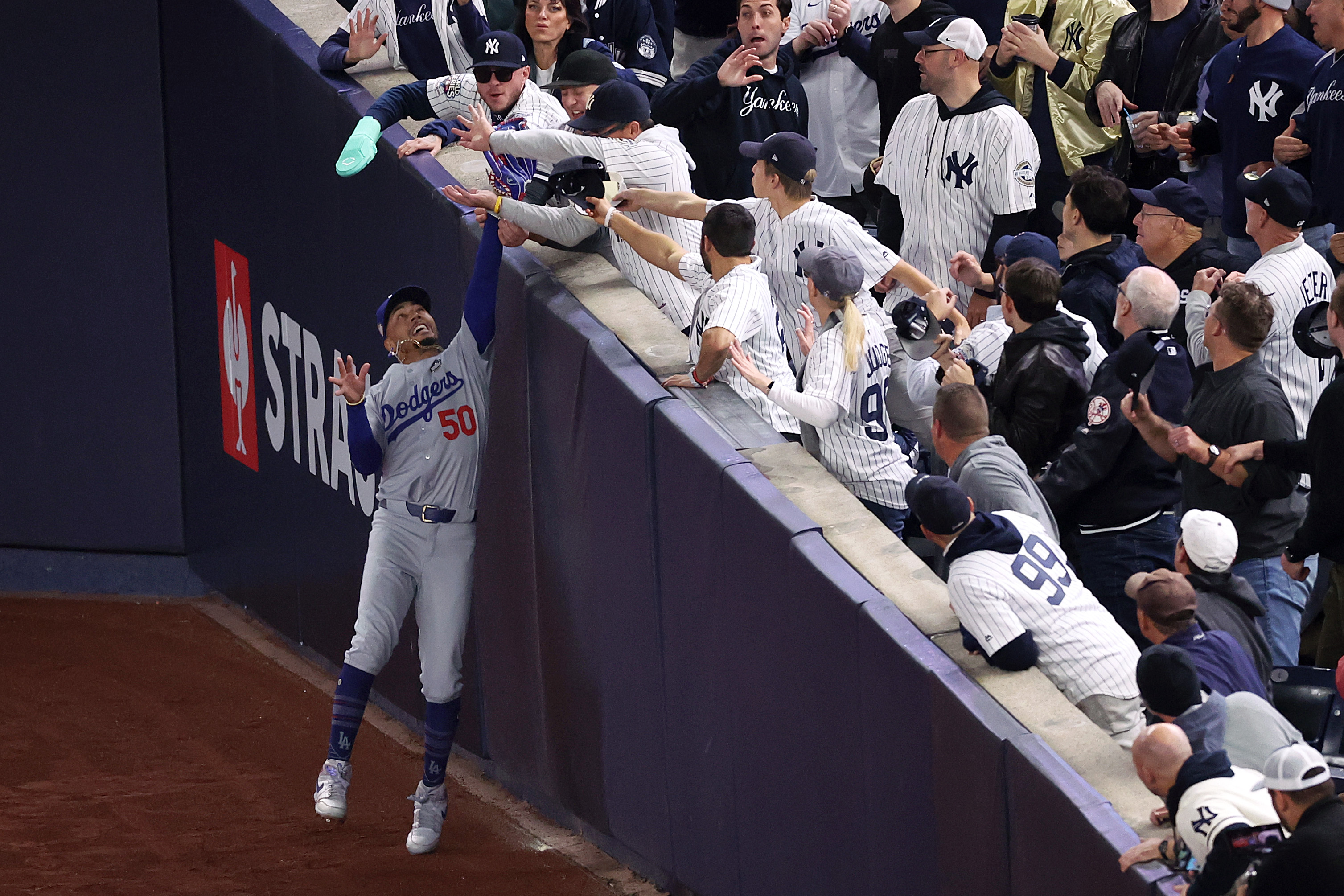 Mookie Betts experiencing fan interference. | Source: Getty Images