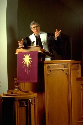 A pastor preaching to his congregation on the pulpit | Photo: Getty Images