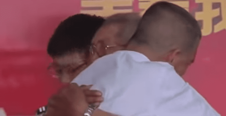 A screenshot from the emotional moment father and son reunited | Photo:  youtube.com/China Today News 