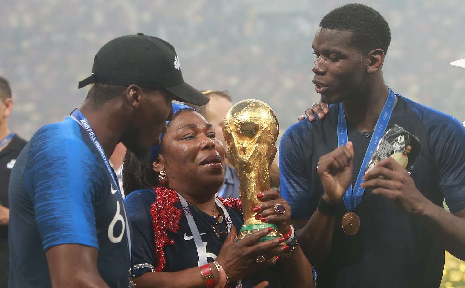 Soccer player, Paul Pogba with his mother, Yeo, and brother, Florentin, holding the world cup trophy. | Photo: Anton Zaitsev, CC BY-SA 3.0, Wikimedia Commons.