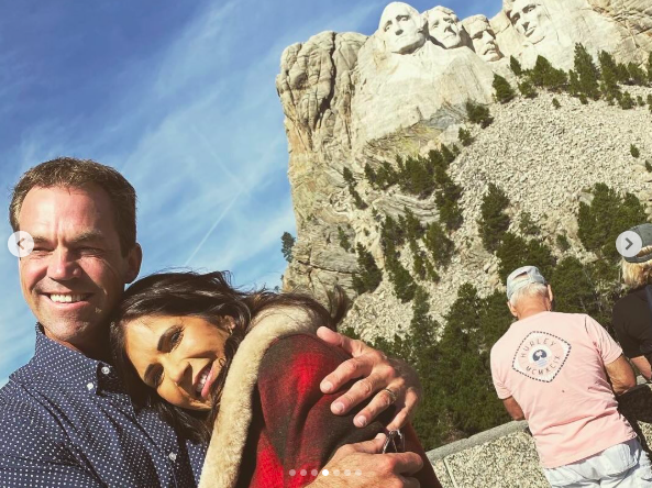 Bryon and Kristi Noem embracing in front of Mount Rushmore. | Source: Instagram/sdbryonnoem