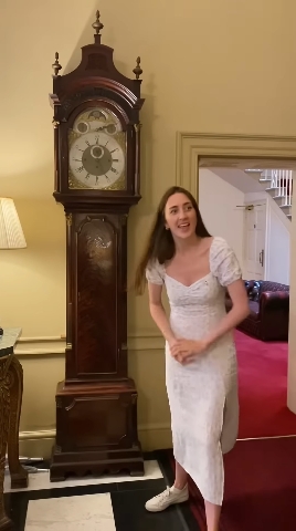 Standing next to an imposing grandfather clock, Loxton showcased the stately character of Downing Street’s interiors, underscoring the long-standing heritage that frames ongoing conversations about contemporary upgrades within the Prime Minister's residence. | Source: YouTube/Alice Loxton