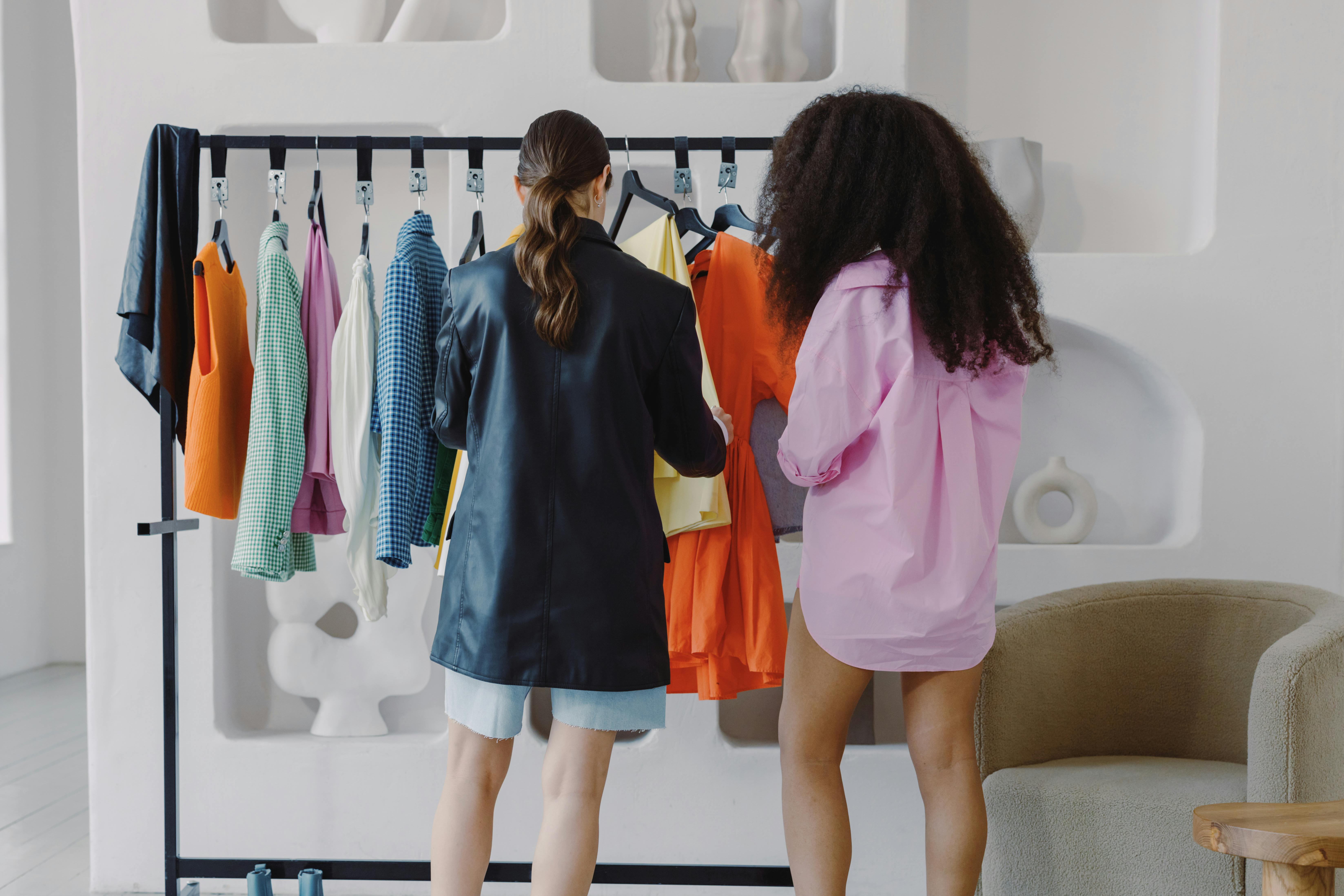 Women looking at clothes on rack | Source: Pexels